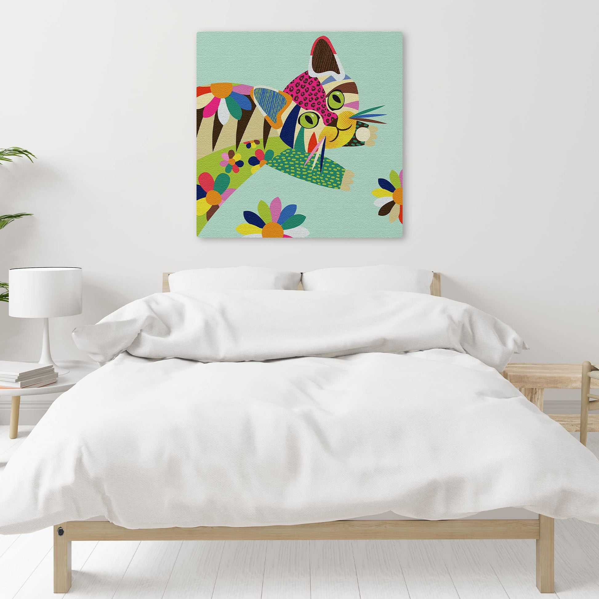 Colorful cute cat kitten wall art with vibrant geometric patterns and bold lines on light teal canvas above bed in modern bedroom