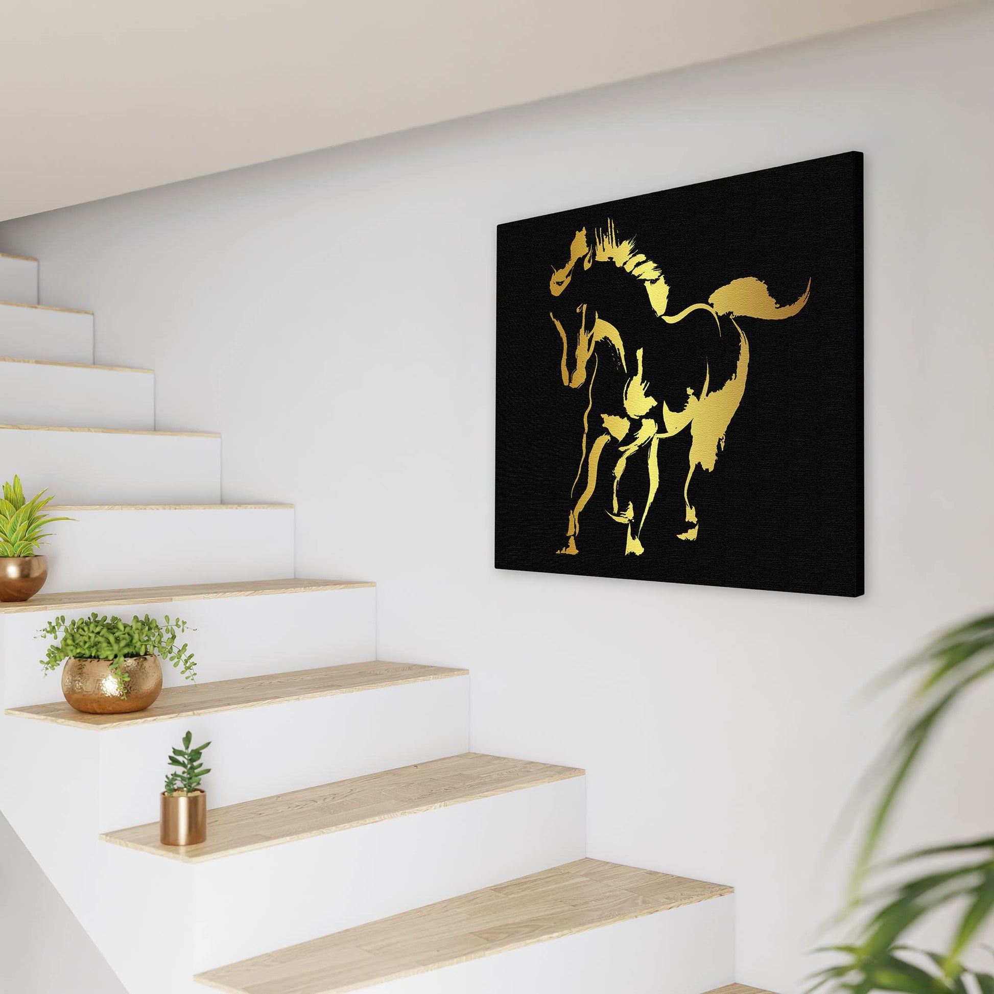 Abstract black and gold silhouette horse art print on textured canvas in modern minimalist staircase setting