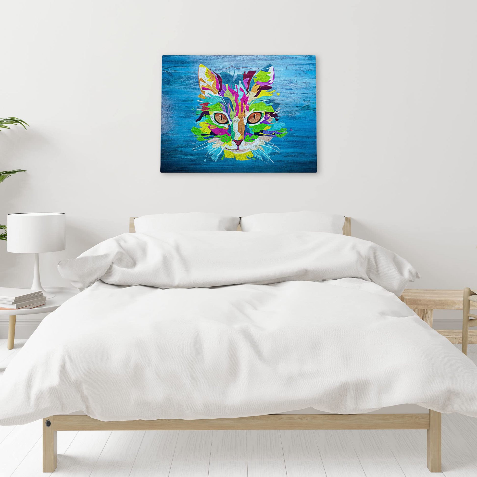 Colorful blue pop art cat wall art with vibrant multicolor geometric shapes and bold lines on bright blue canvas above bed