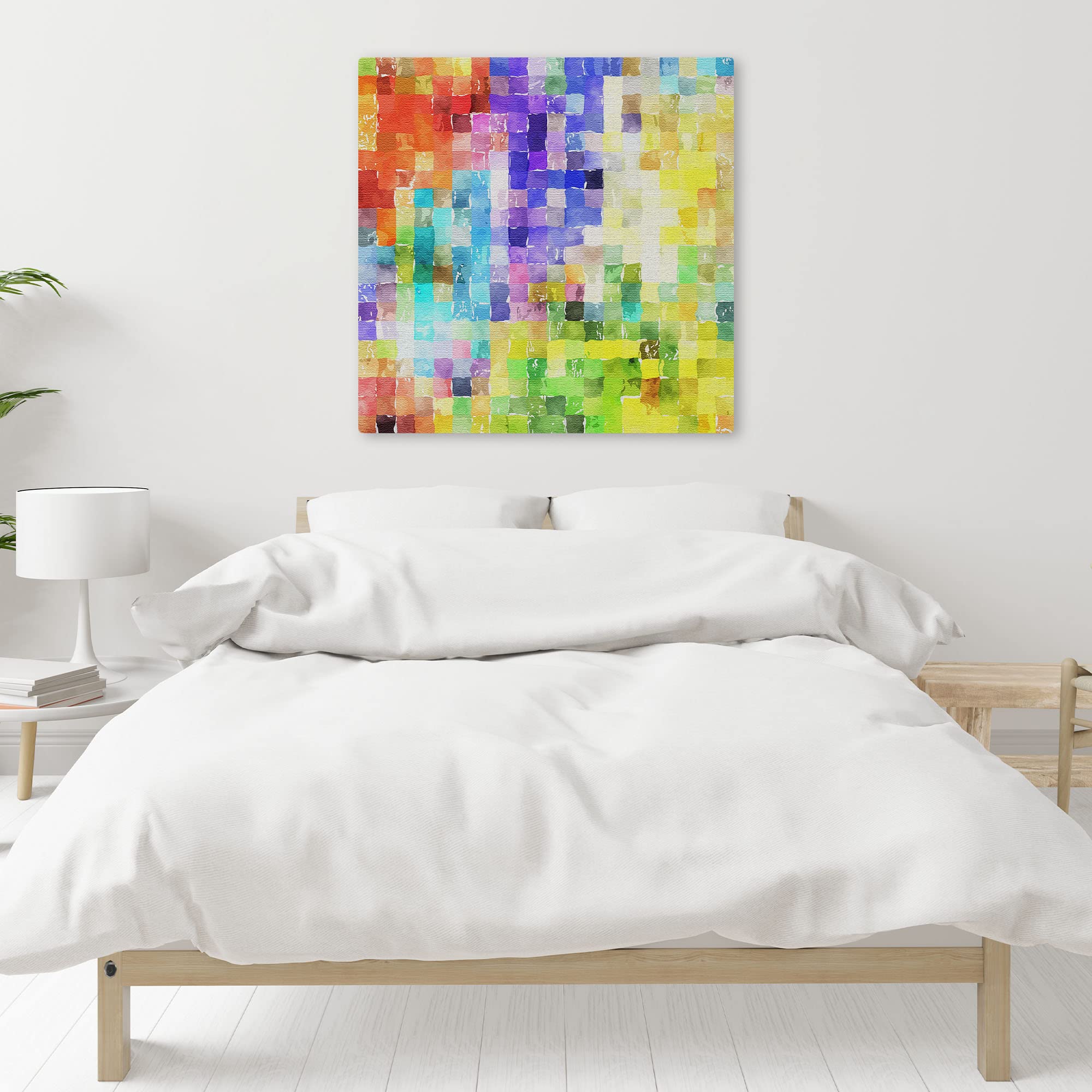 Colorful abstract watercolor mosaic wall art on square canvas displayed above bed in bright minimalist bedroom