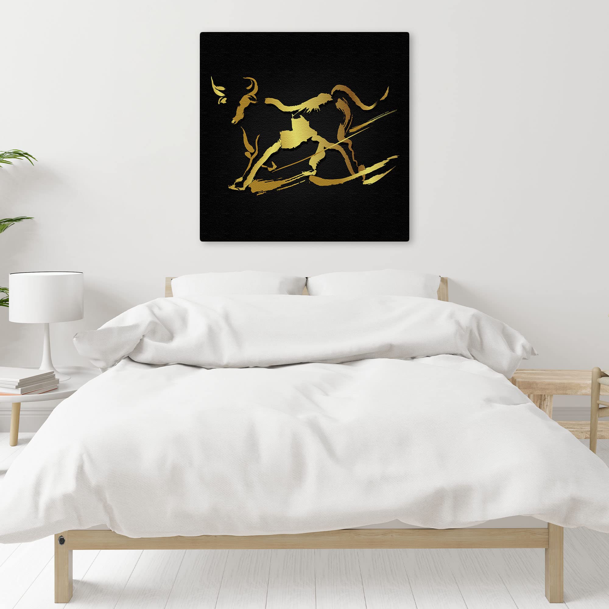 Abstract black and gold bull wall art with sleek minimalist design on square canvas above bed in modern bedroom