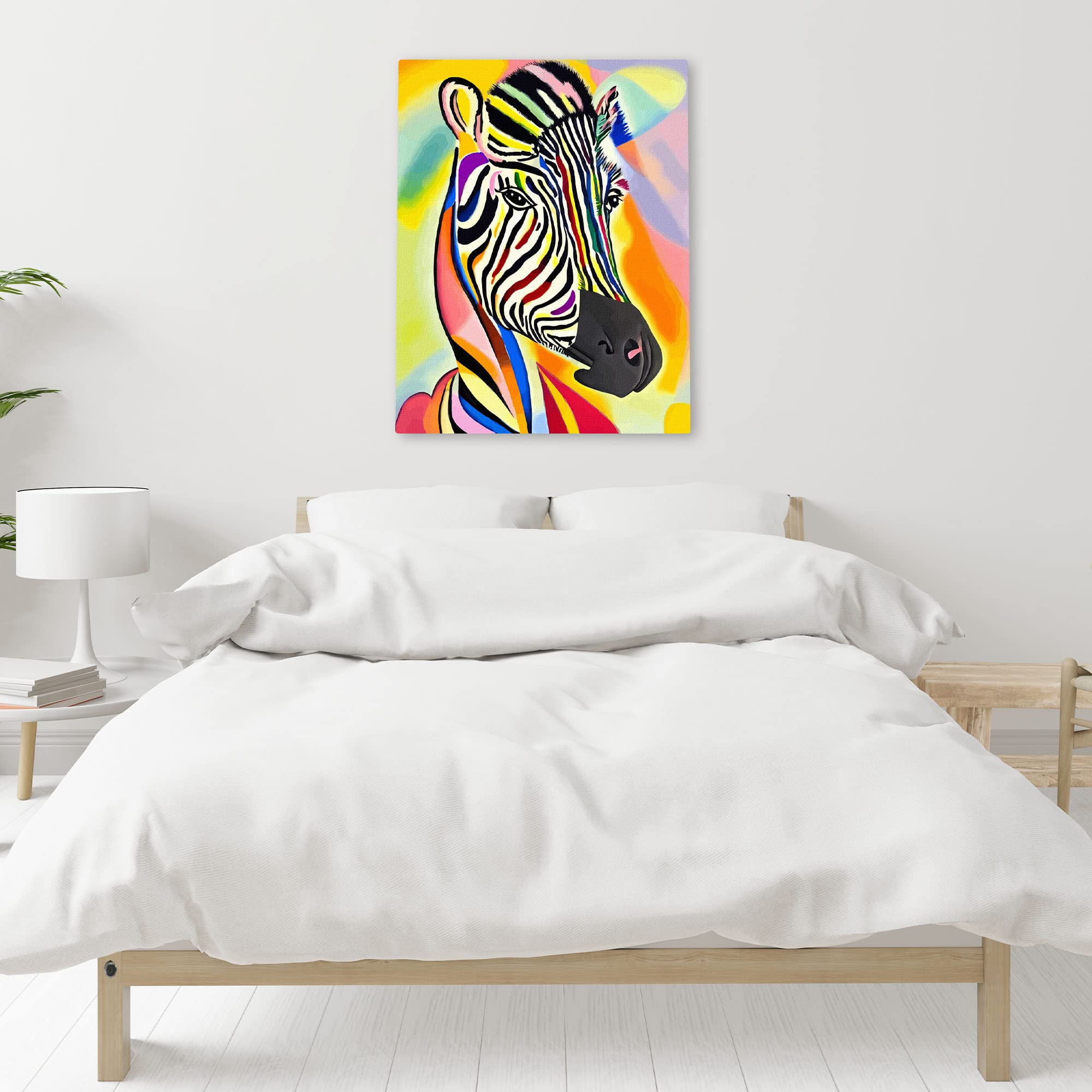 Colorful abstract zebra portrait with bright rainbow stripes printed on canvas hanging above bed in modern bedroom