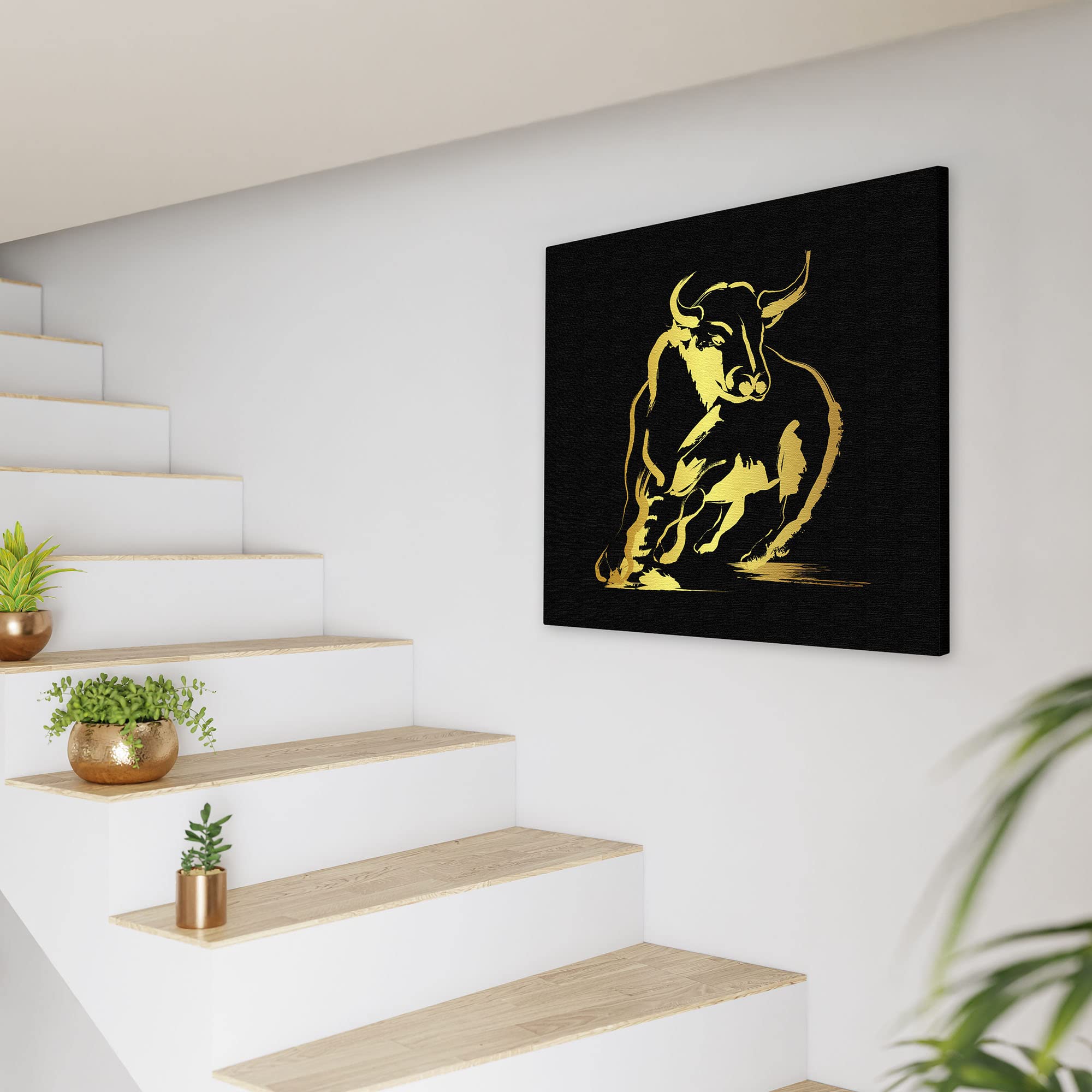 Abstract black and gold bull art with dynamic brushstroke design on square canvas displayed on white wall near staircase
