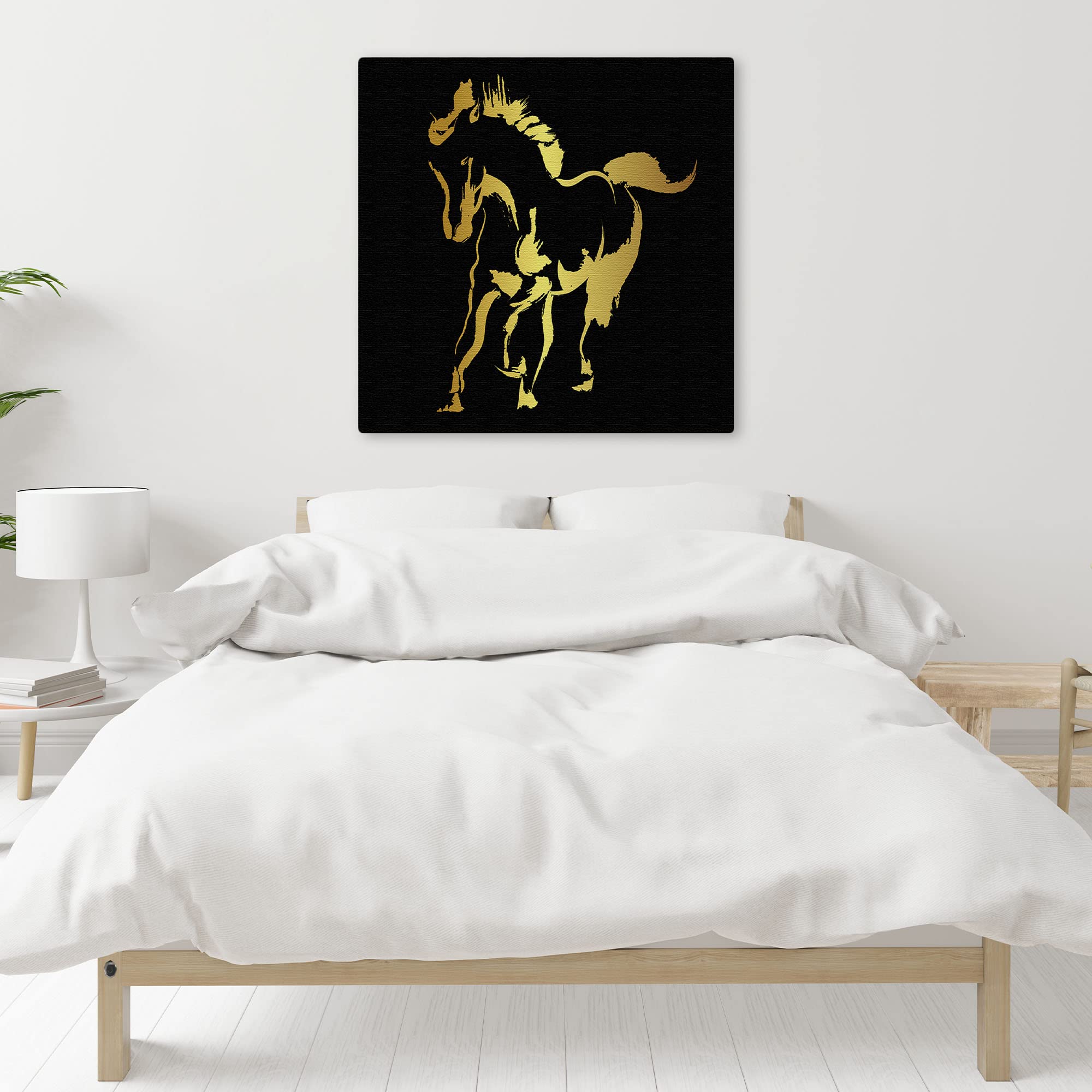 Abstract black and gold silhouette horse art print on textured canvas in modern minimalist bedroom setting