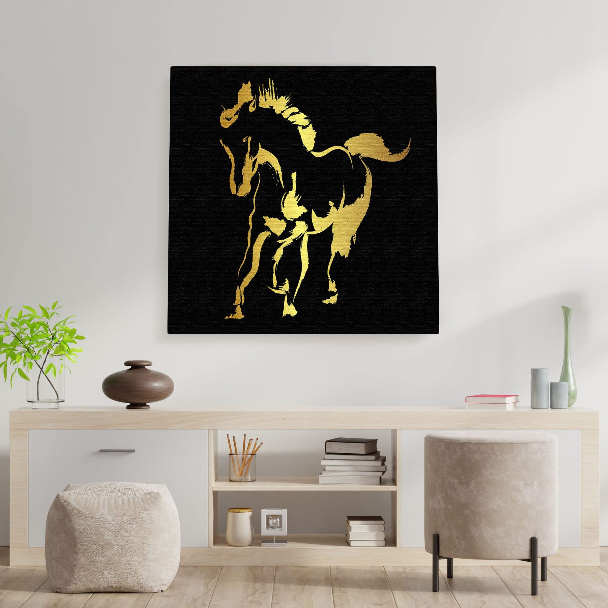Abstract black and gold silhouette horse art print on textured canvas in modern minimalist living room setting