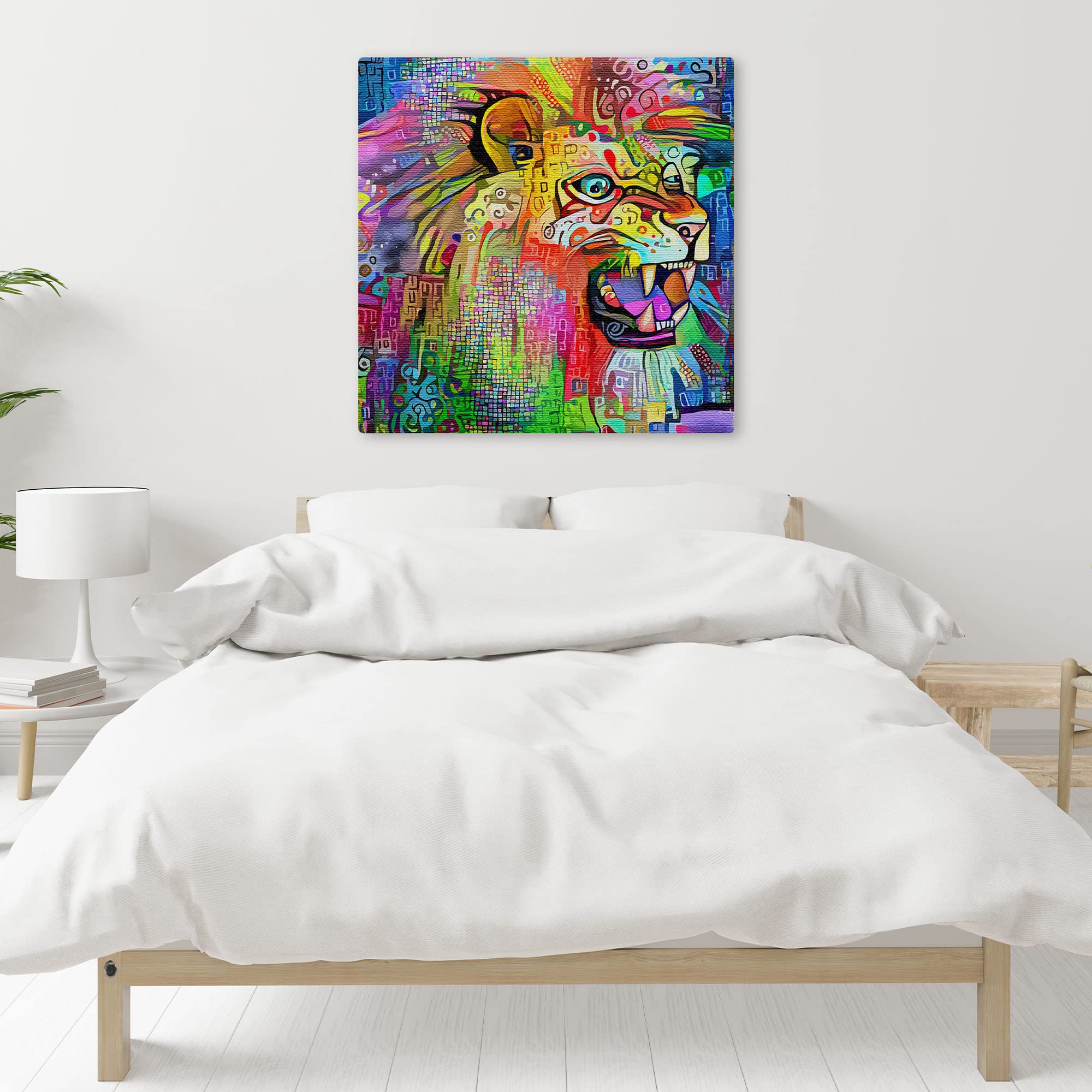 Vibrant multicolored abstract lion artwork on square canvas displayed on white bedroom wall above simple wooden bed