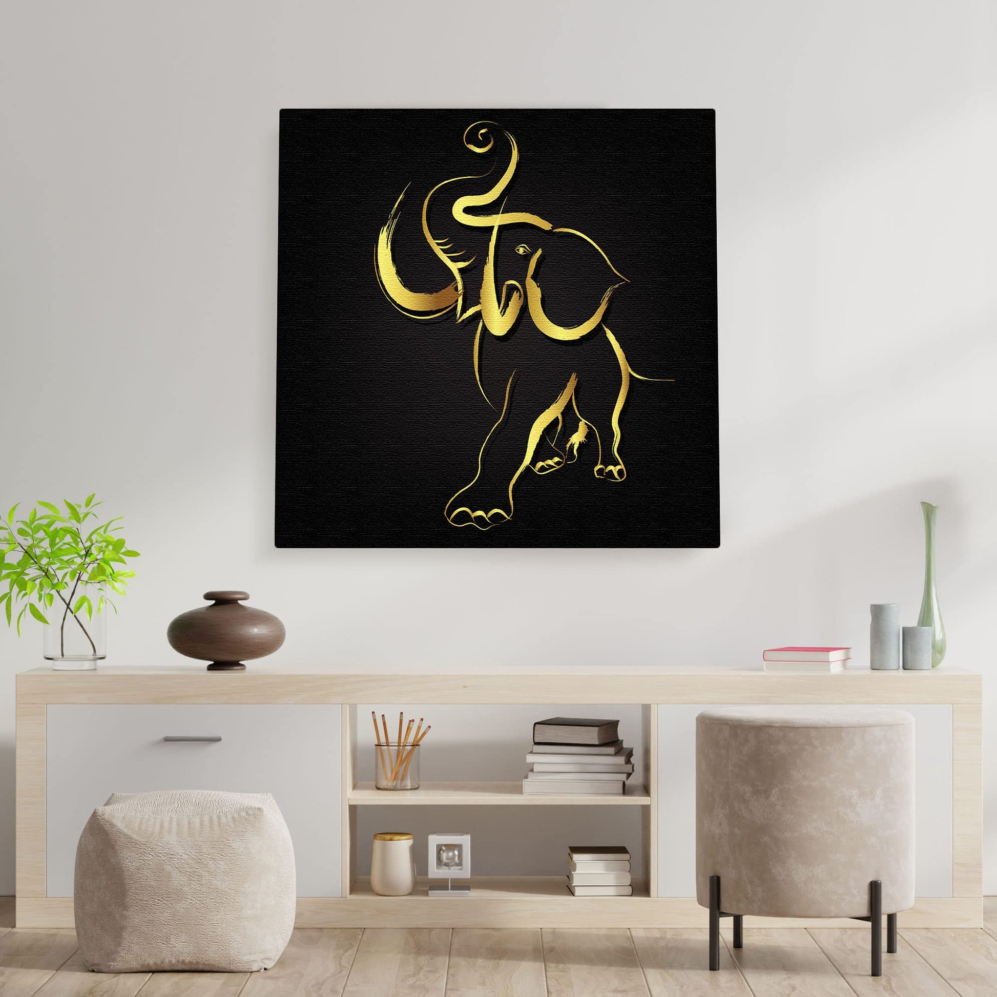 Abstract black and gold elephant art with elegant lines on canvas hanging above modern wooden console with decor