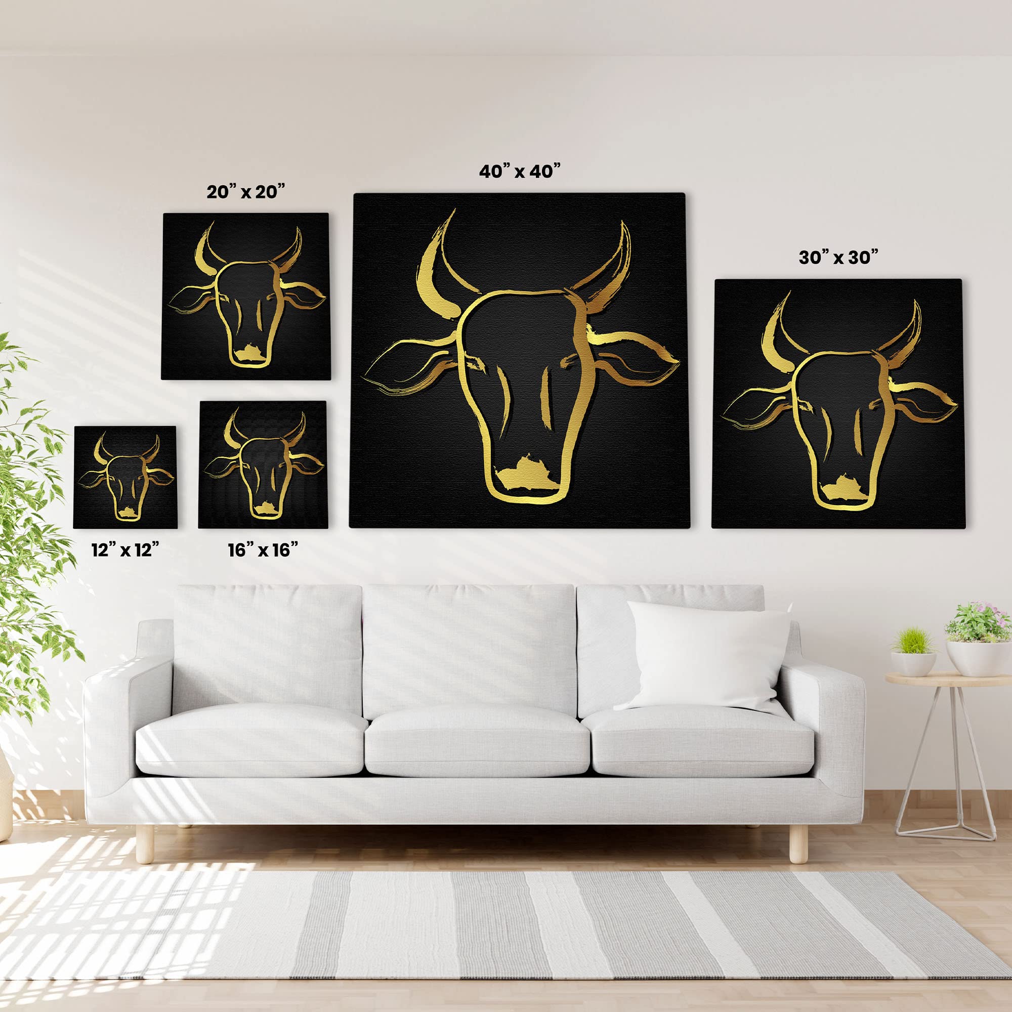 Black and gold abstract cow art in multiple sizes displayed on white wall above modern white sofa in living room