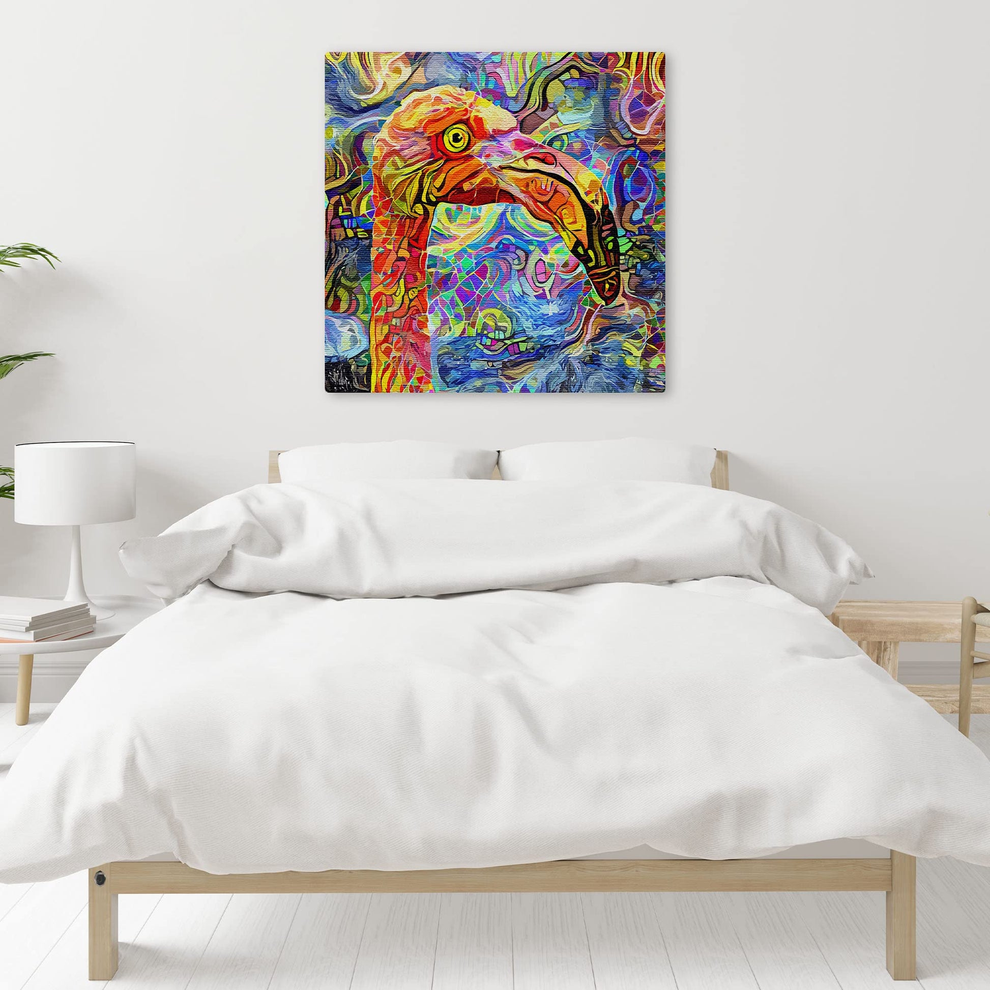 Colorful quirky abstract flamingo bird art with vivid patterns hanging on white wall above bed in modern minimalist bedroom