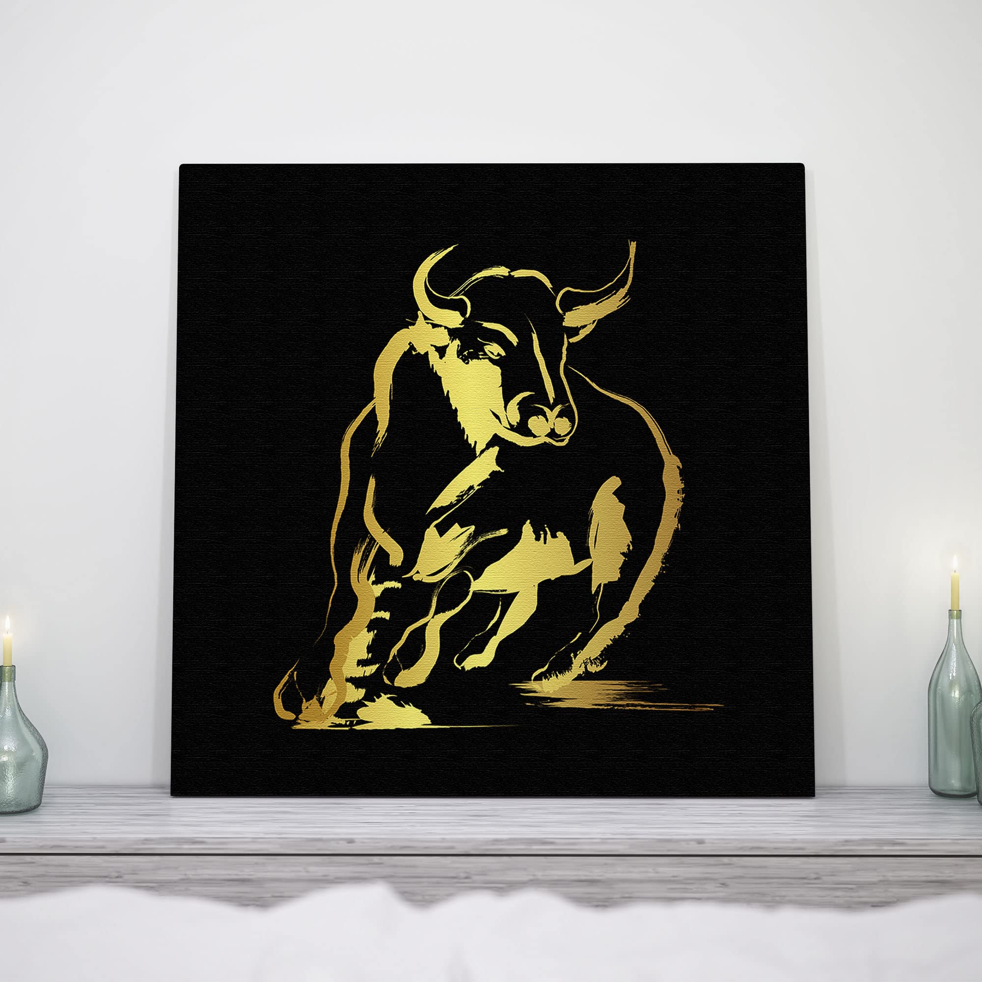 Abstract gold and black bull art with fluid brushstroke design on square canvas displayed on white wall above mantelpiece