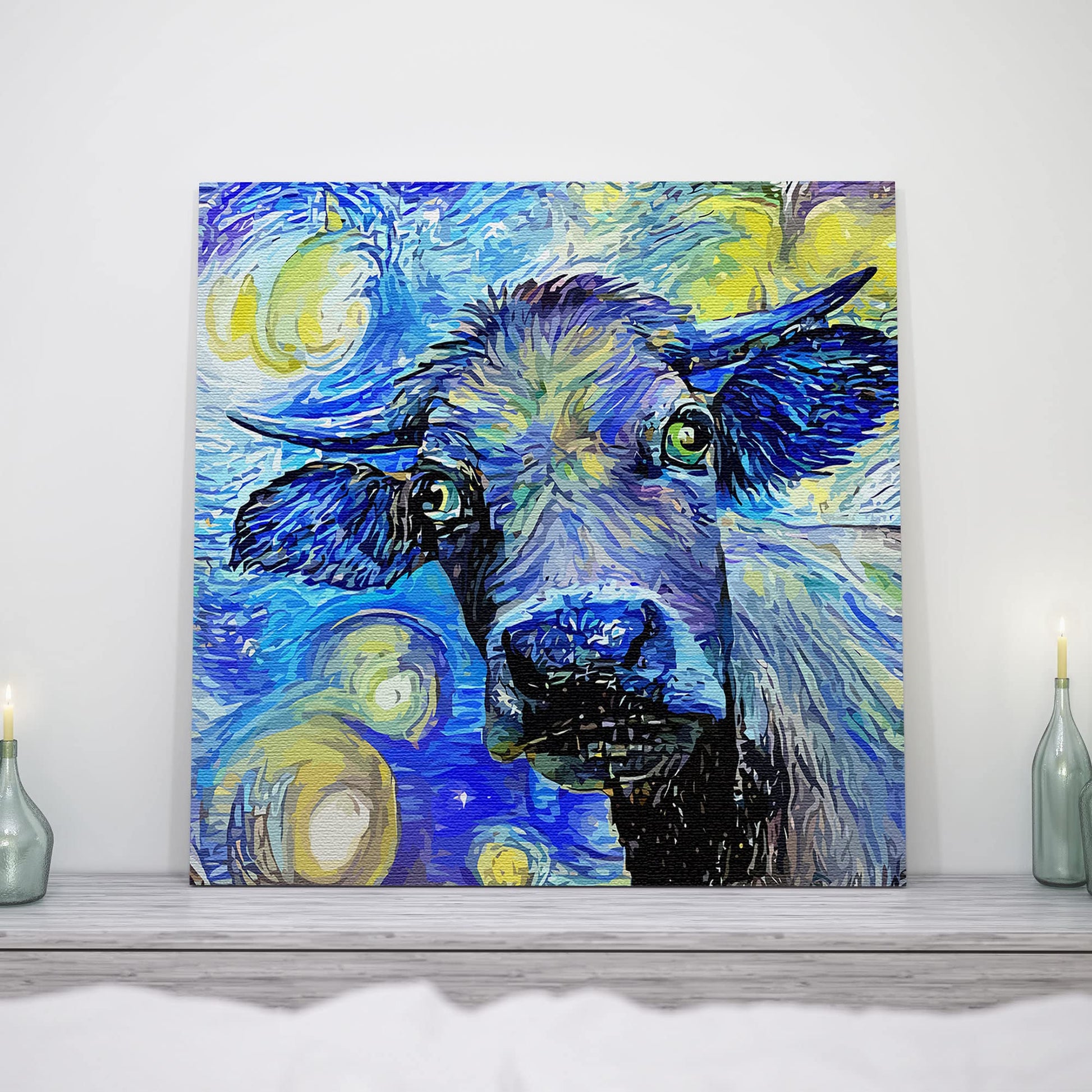 Blue abstract cow painting with expressive swirling brushstrokes on square canvas displayed on mantel with candles