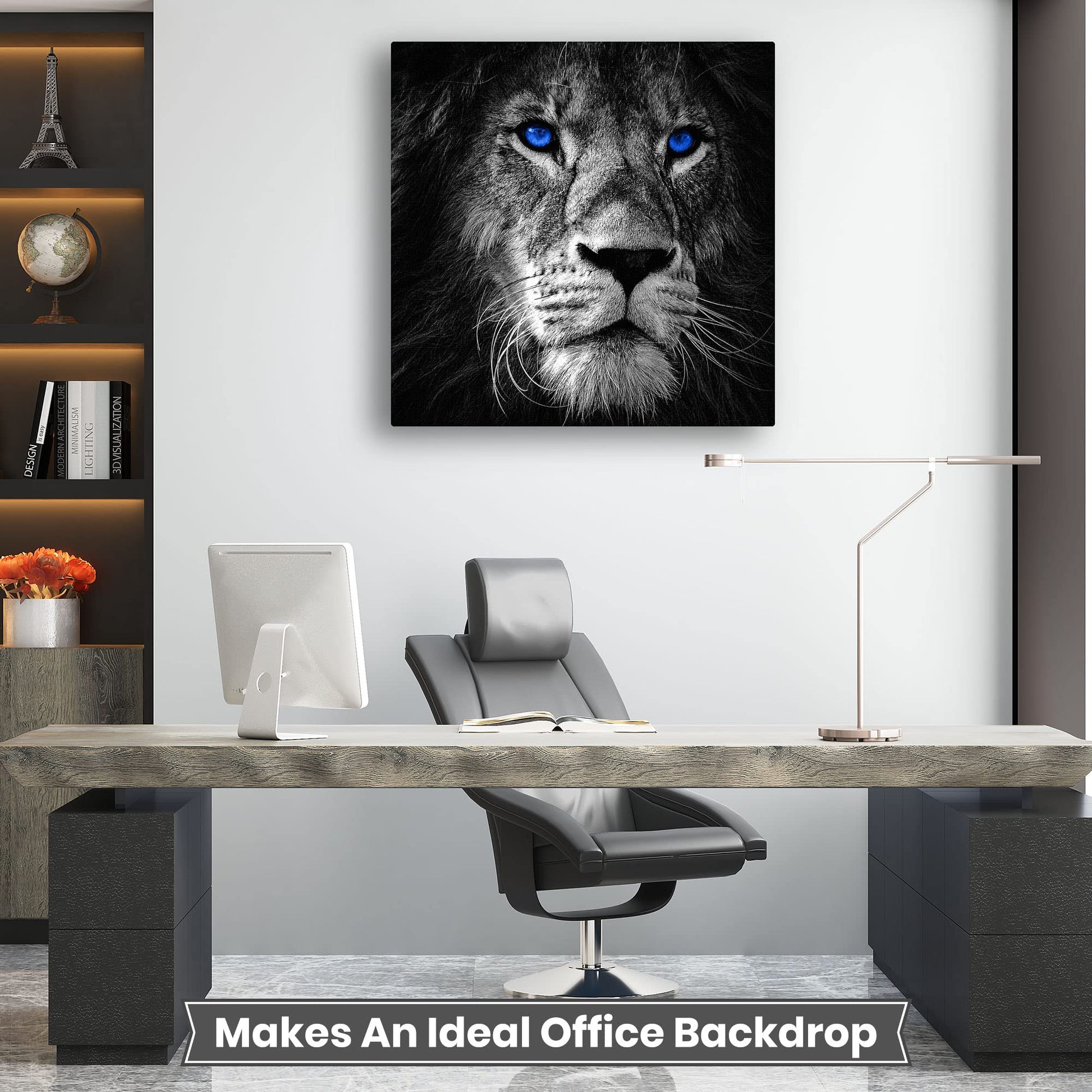 Close-up black and white lion portrait with striking blue eyes displayed as wall art above modern office desk and chair