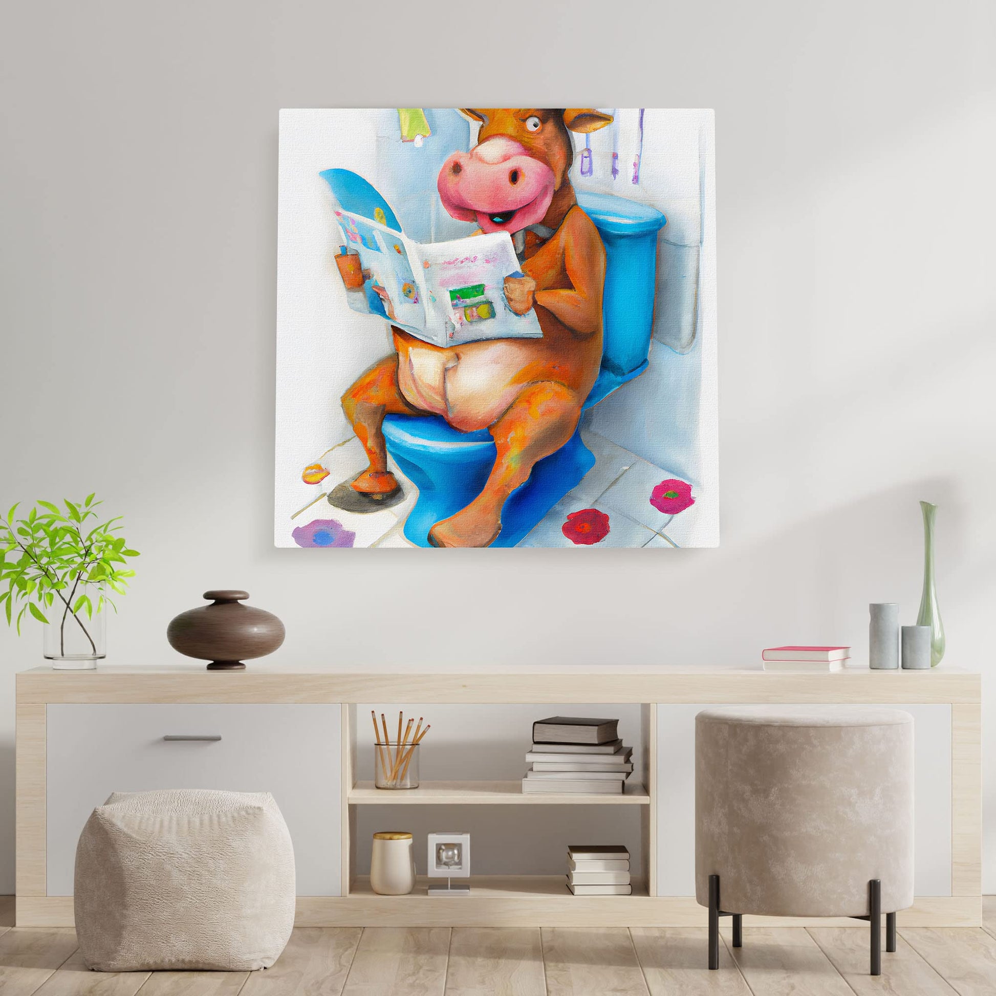 Colorful quirky funny cow bathroom wall art with cartoon cow sitting on blue toilet reading newspaper with bathroom decor and floor flowers