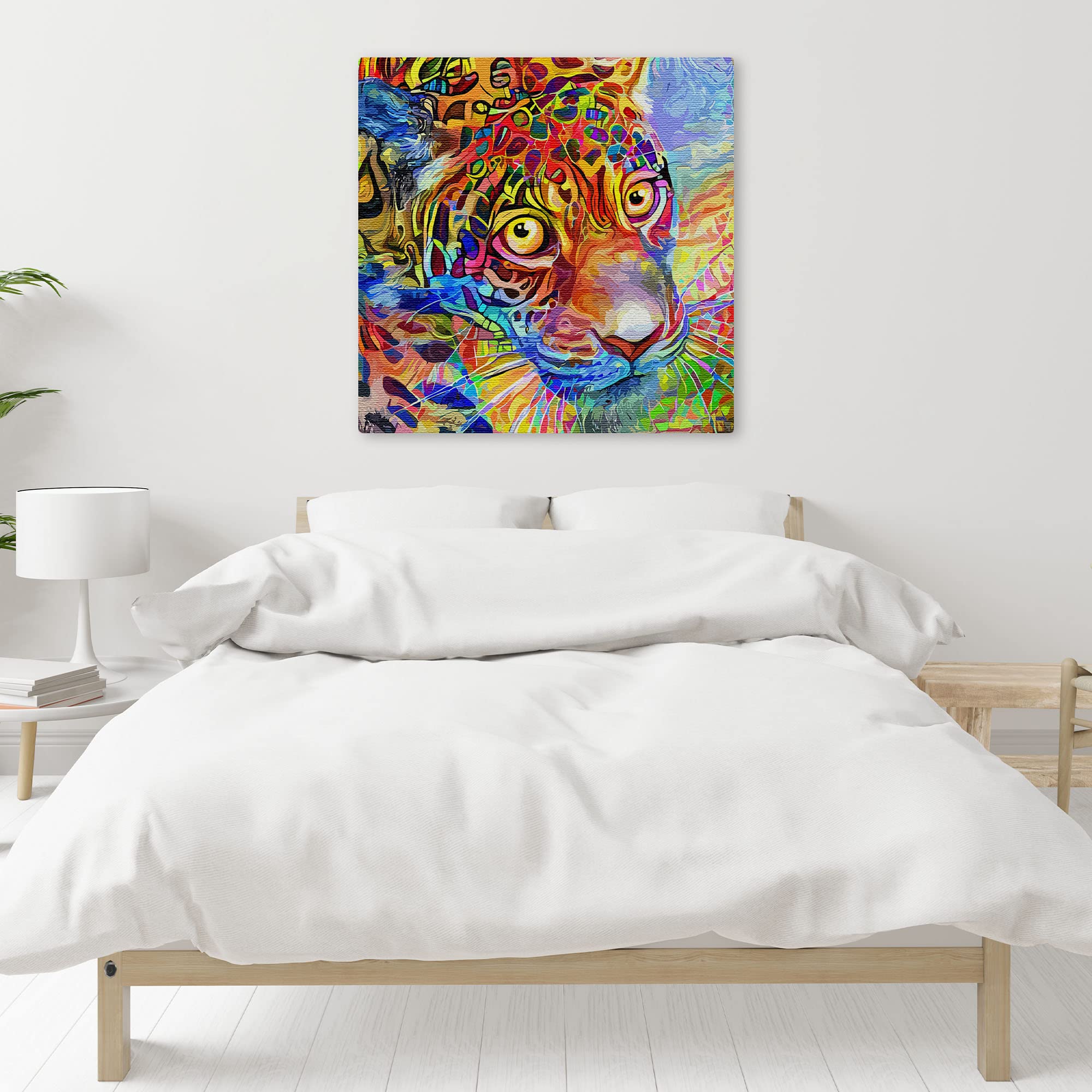 Colorful abstract leopard face wall art with vivid geometric patterns on textured canvas above bed in bright minimalist bedroom