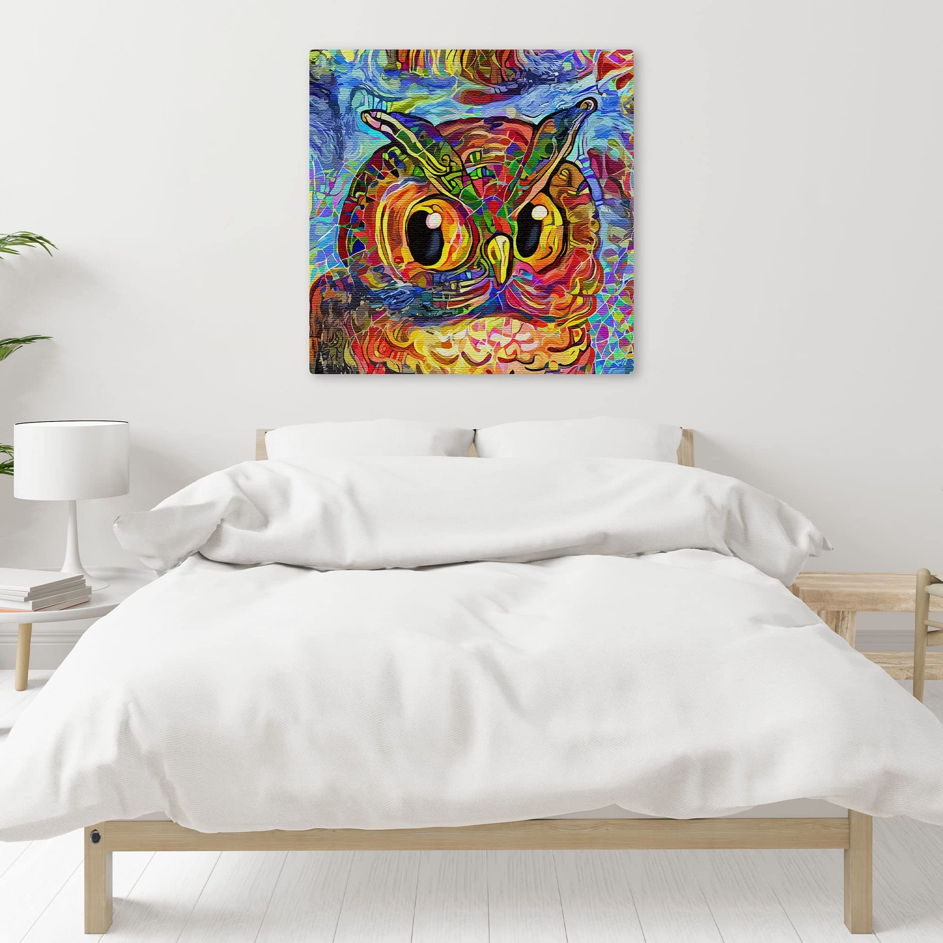 Colorful abstract owl with vibrant swirling patterns on square canvas wall art above bed in minimal bedroom setting