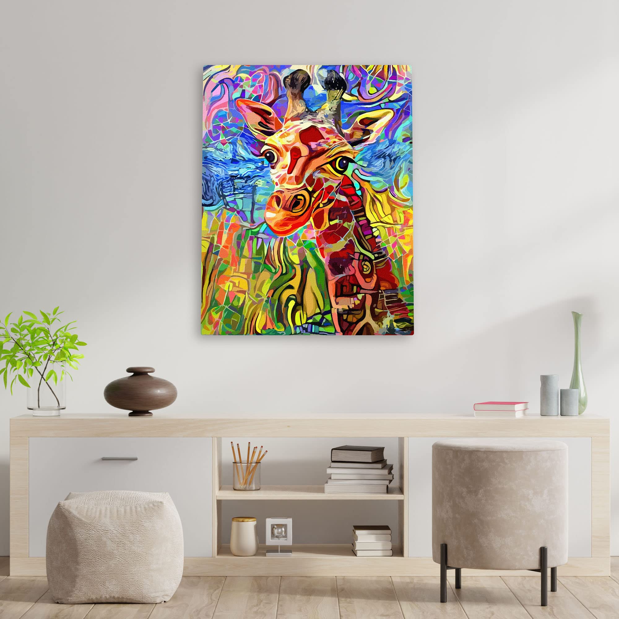 Colorful abstract giraffe portrait with vibrant patterns printed on canvas hanging on white wall above wooden console table