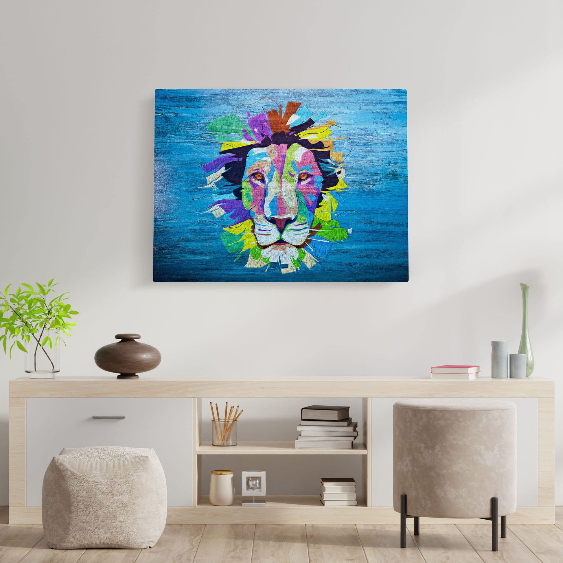 Vibrant pop art lion artwork on blue canvas displayed on white living room wall above modern wooden console with plants and decor