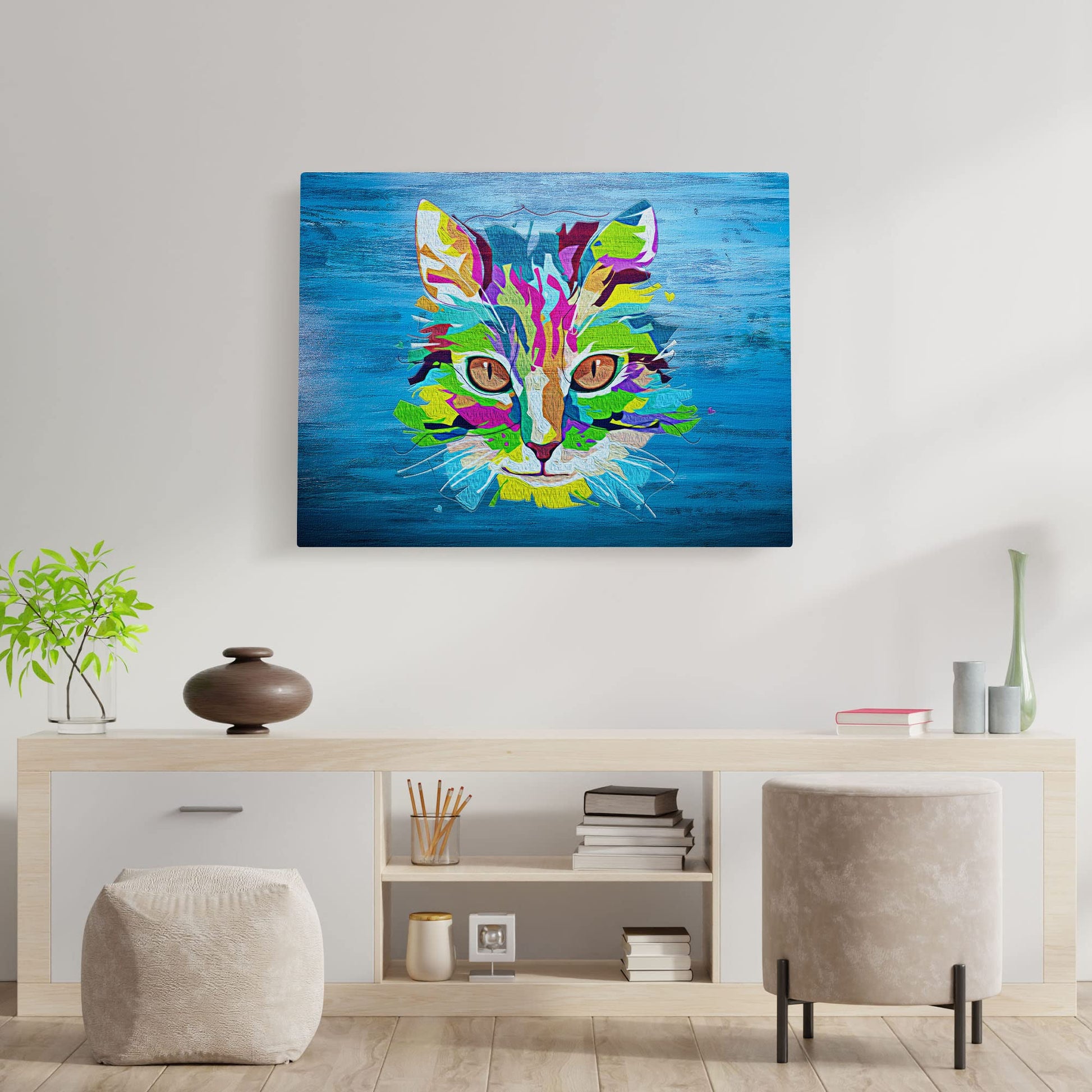 Colorful blue pop art cat wall art with vibrant multicolor geometric shapes and bold lines on textured blue canvas hanging above console table