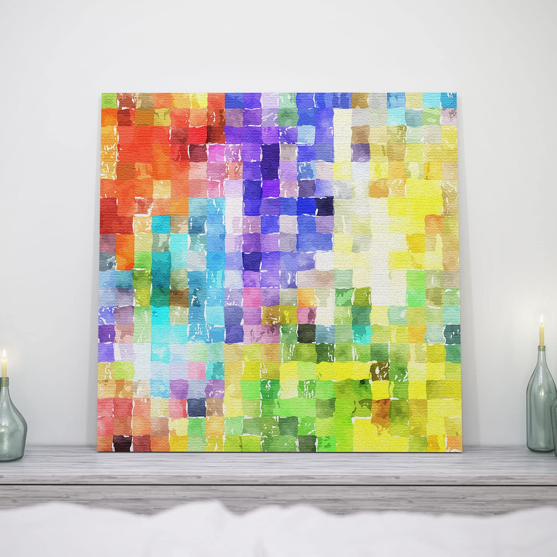 Colorful abstract watercolor mosaic wall art on square canvas displayed on mantel with candles in bright room