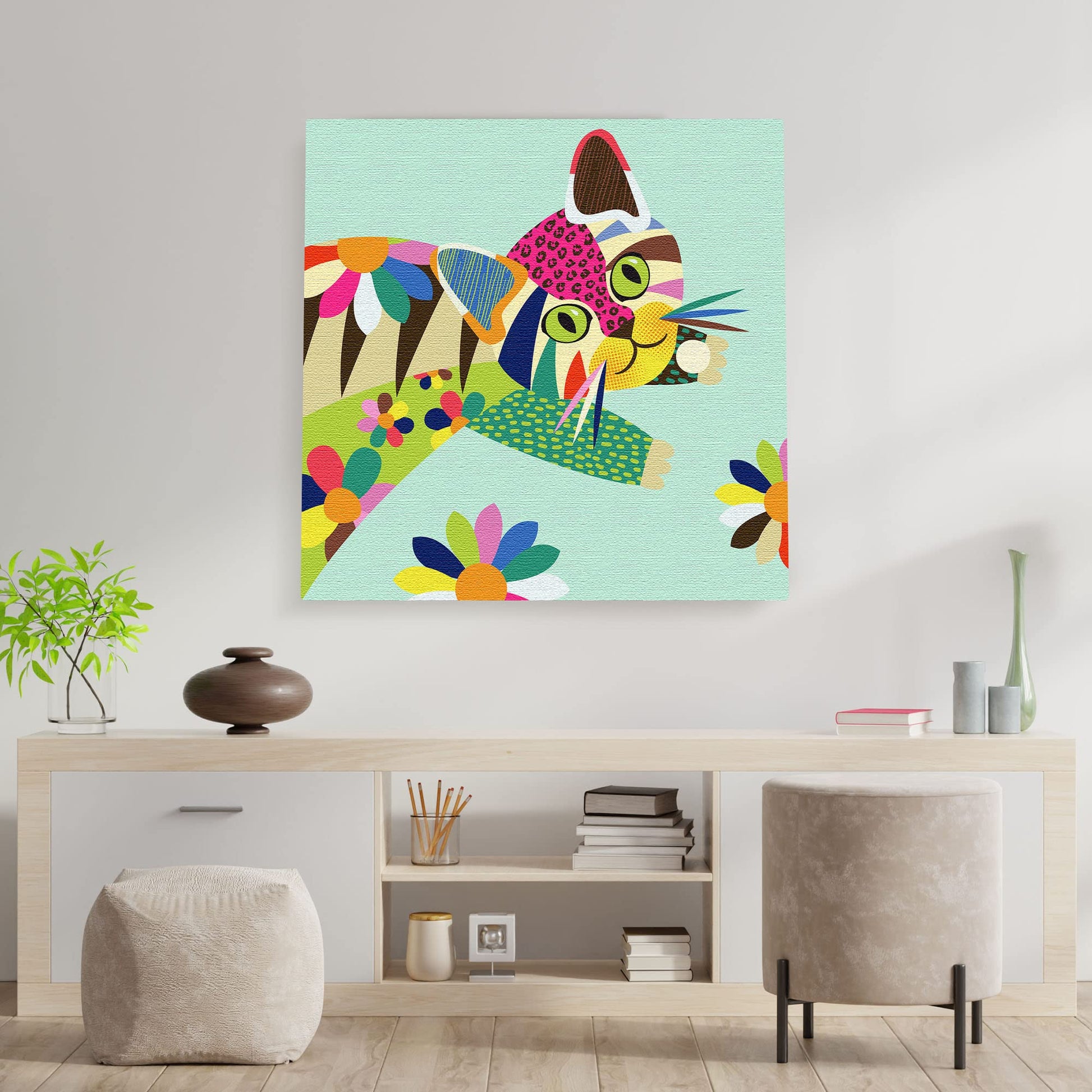 Colorful cute cat kitten wall art with vibrant geometric patterns and bold lines on light blue canvas above modern console table