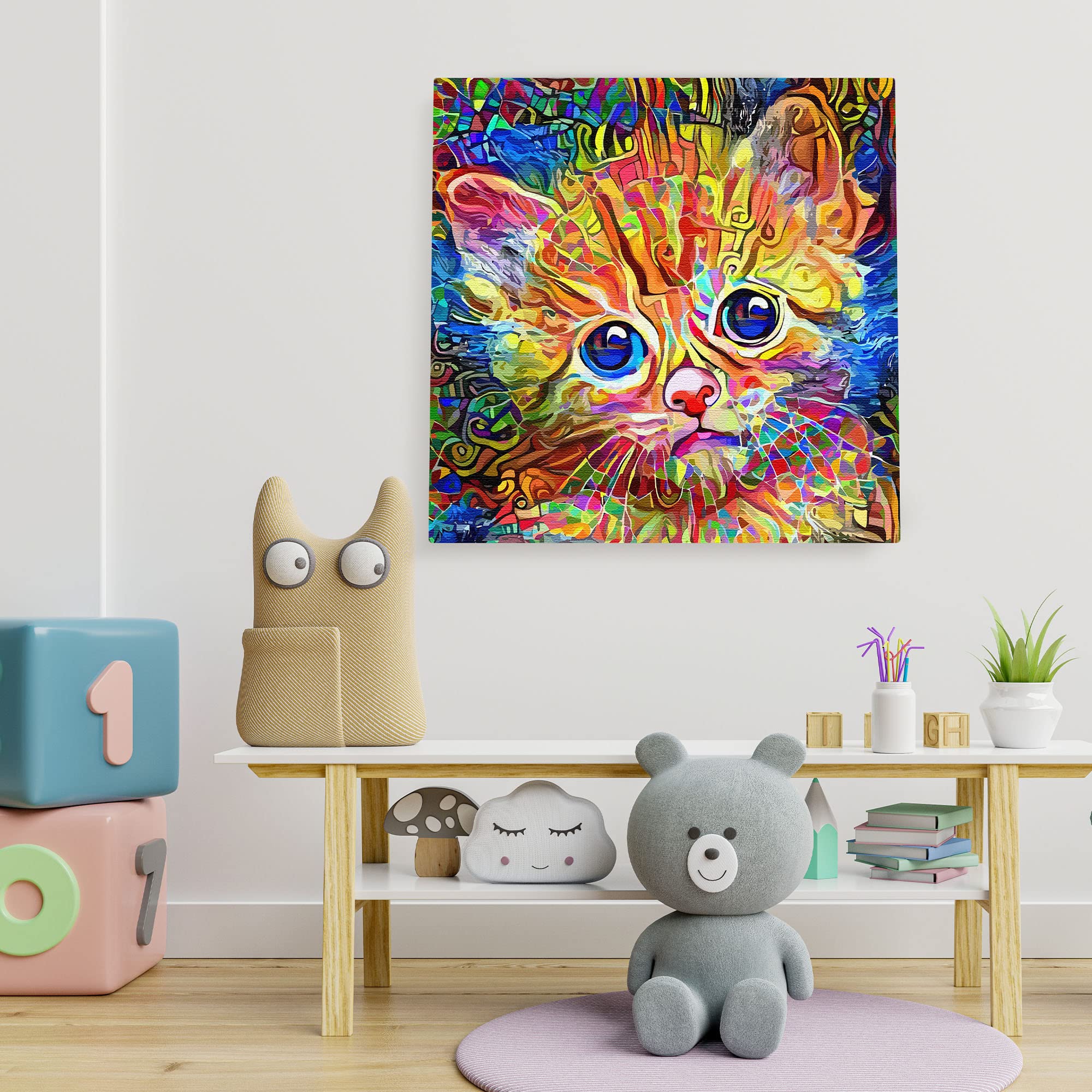 Abstract colorful cat art canvas featuring a wide-eyed kitten with vibrant orange, blue, and green swirling patterns on a white wall background