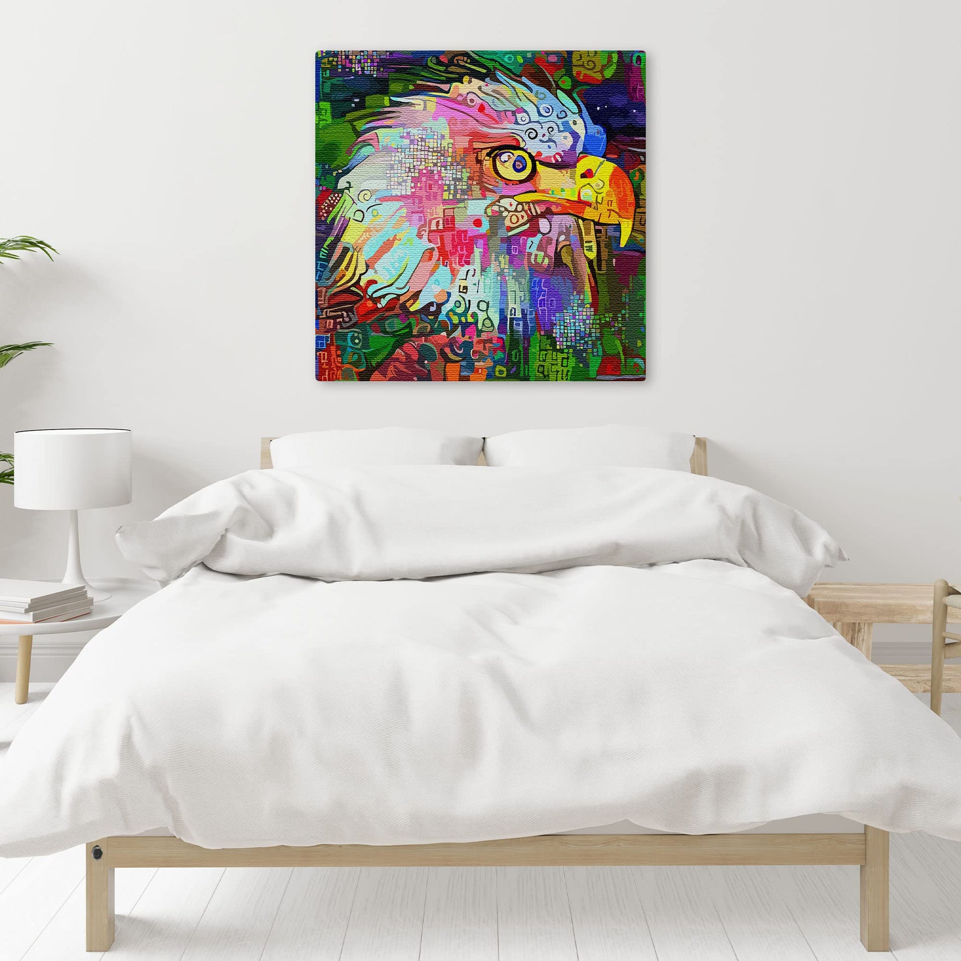 Colorful abstract eagle wall art with vibrant geometric and digital patterns on square canvas above minimalist bed in bright bedroom