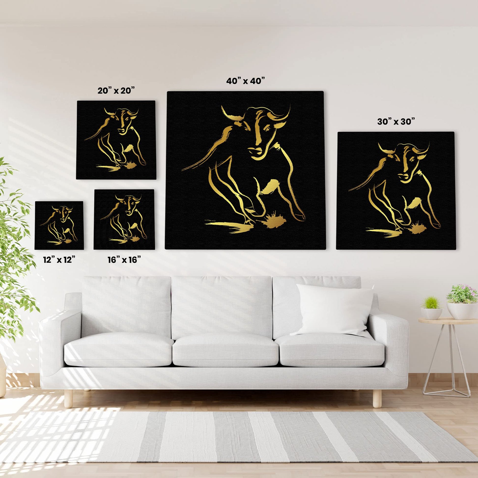 Black and gold abstract bull art in five size options displayed above white sofa in modern living room