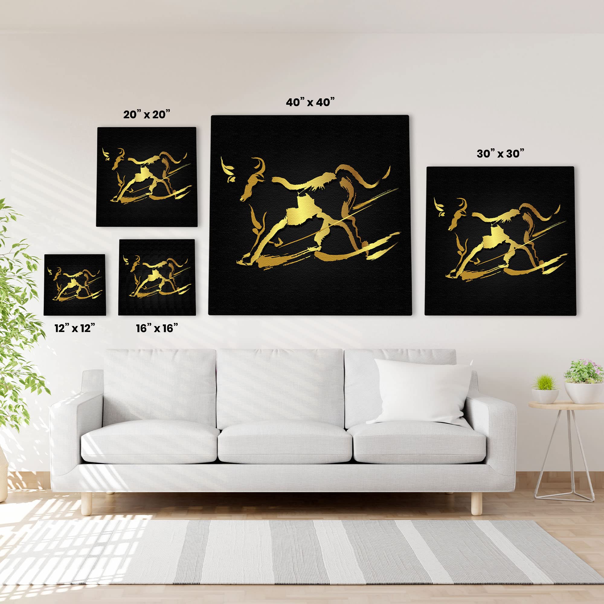 Abstract black and gold bull wall art in five size options displayed above white sofa in modern living room