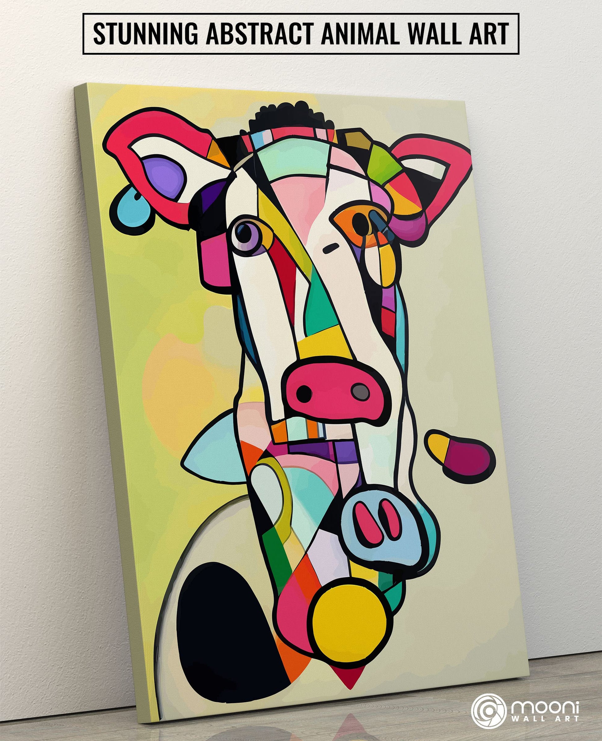 Abstract cow art canvas with vibrant geometric shapes and bold colors displayed leaning against light wall