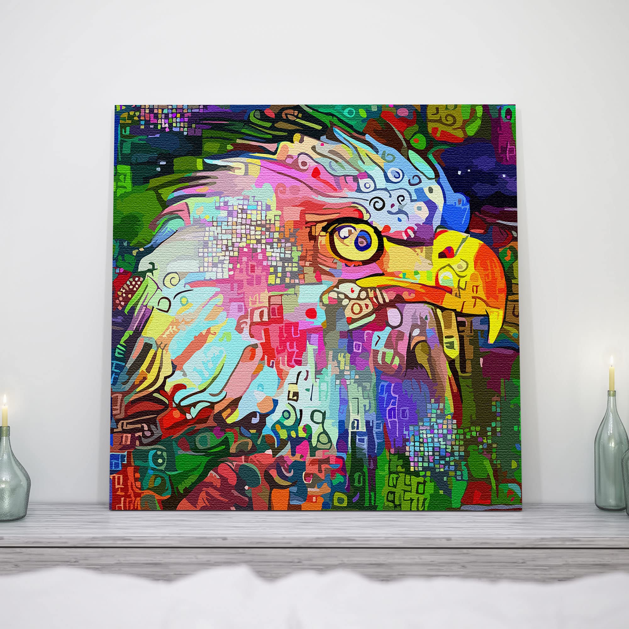 Colorful abstract eagle head wall art with vivid geometric and digital patterns on square canvas displayed on mantel with candles