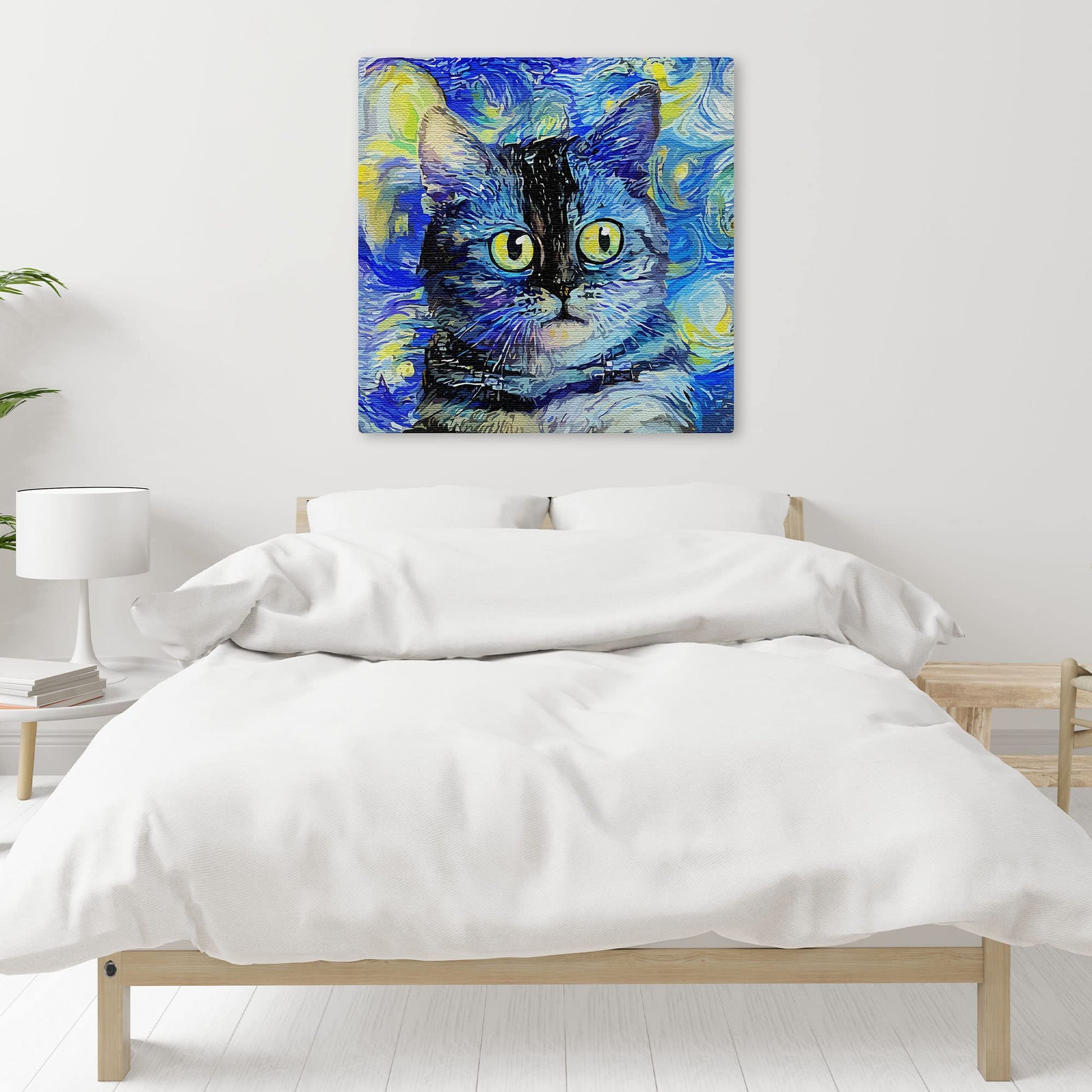 Blue impressionist cat canvas art with swirling brushstrokes and bright yellow eyes displayed above modern bed