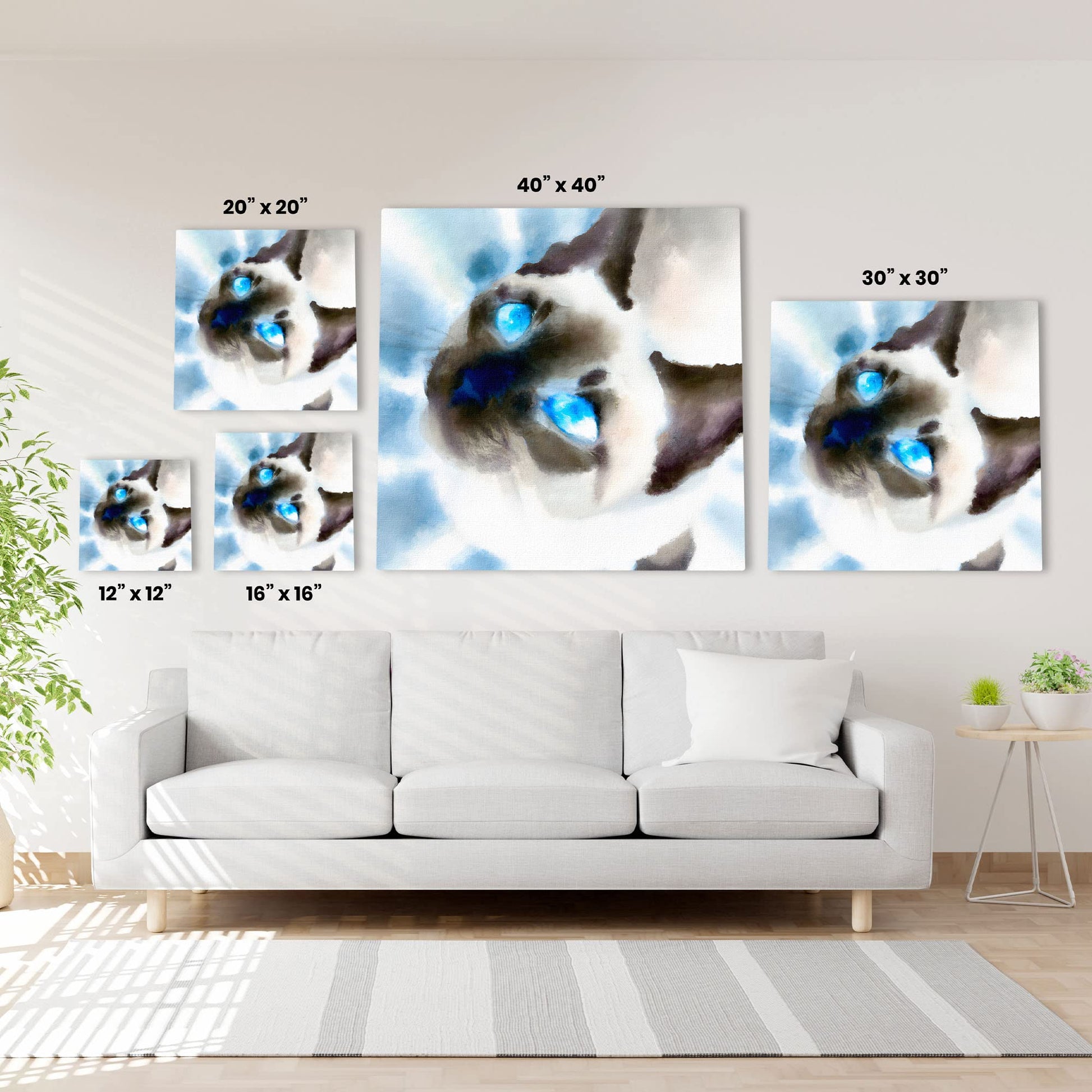 Close-up Siamese cat wall art watercolor with bright blue eyes and soft brush strokes on various sized square canvases above white sofa