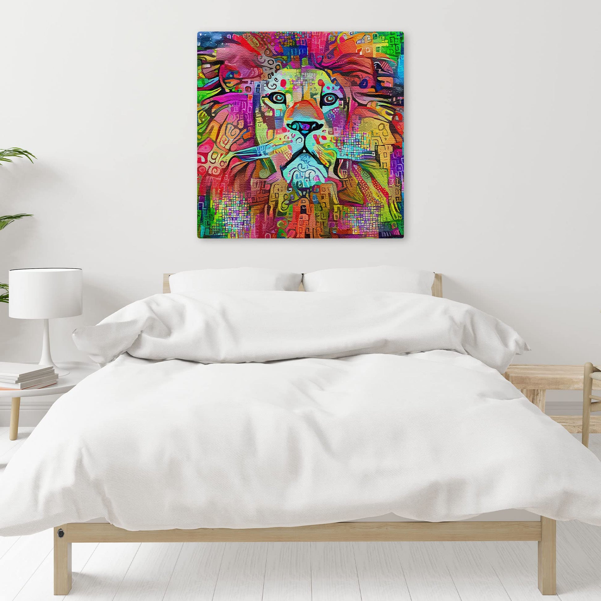 Vibrant colorful abstract lion artwork on square canvas displayed on white bedroom wall above simple wooden bed with white bedding