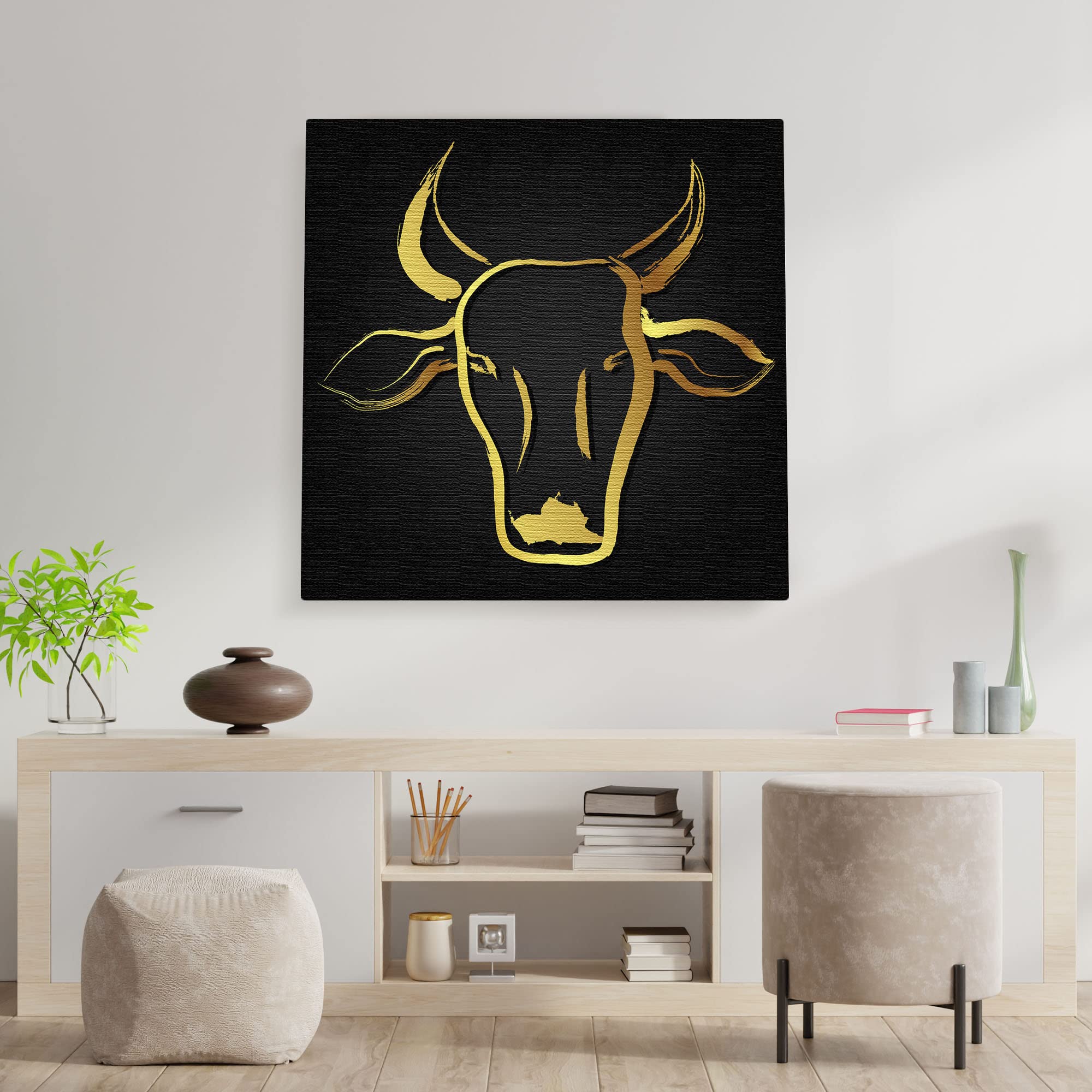 Abstract black and gold cow art with sleek brushstroke design on square canvas displayed above modern console table