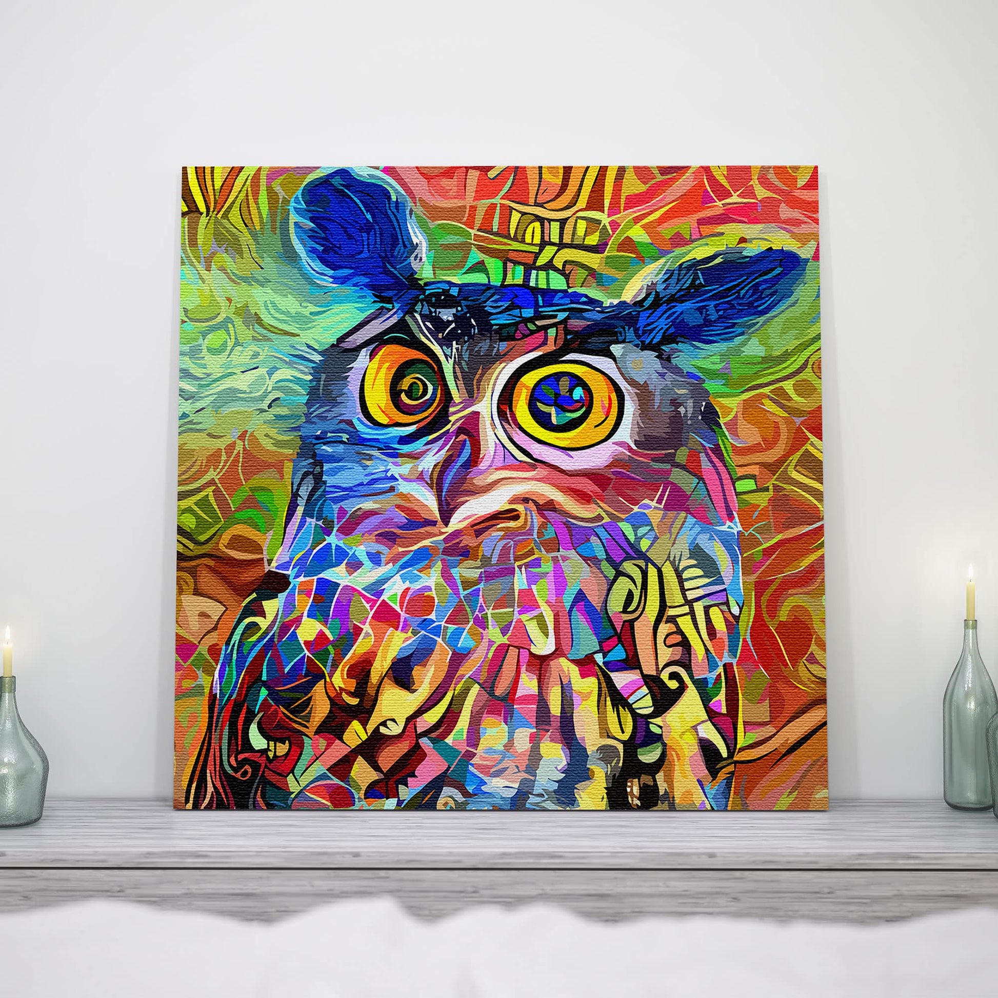 Vibrant geometric mosaic owl with colorful abstract patterns on square canvas artwork displayed on rustic mantelpiece