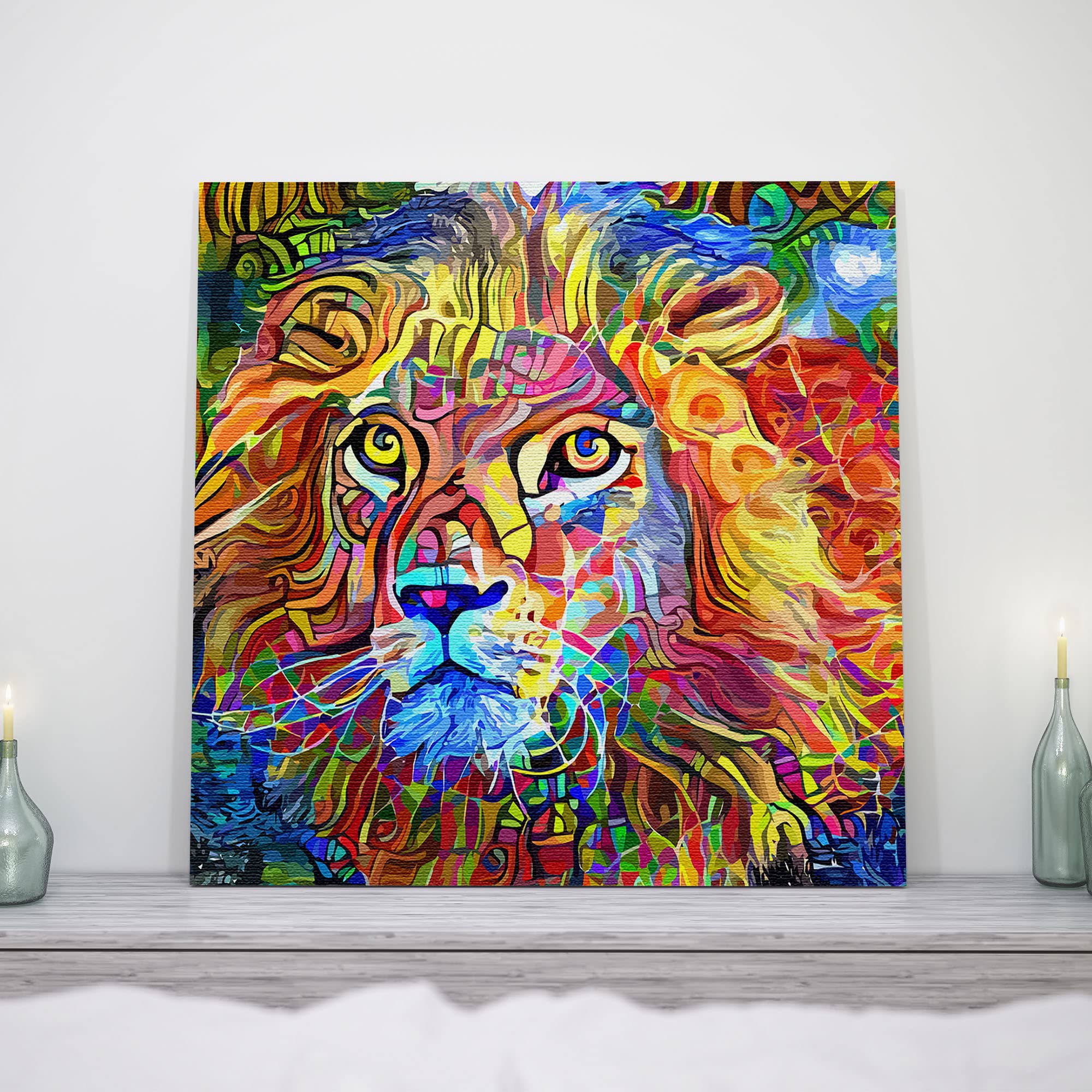 Vibrant colorful abstract king of the jungle lion artwork on square canvas displayed on white wall above gray mantle with candles