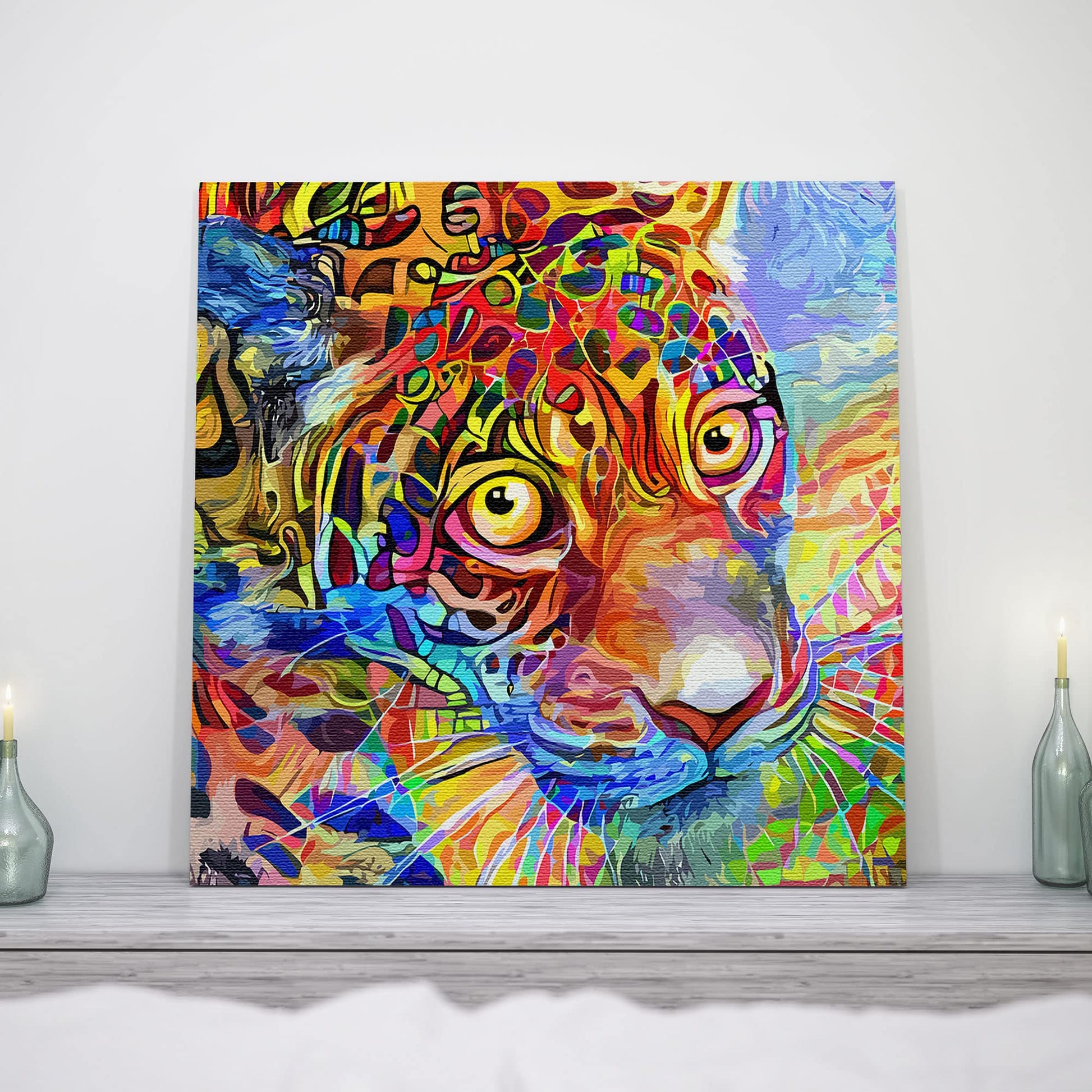 Vibrant abstract leopard face wall art with multicolor geometric patterns on textured canvas displayed on light wood surface