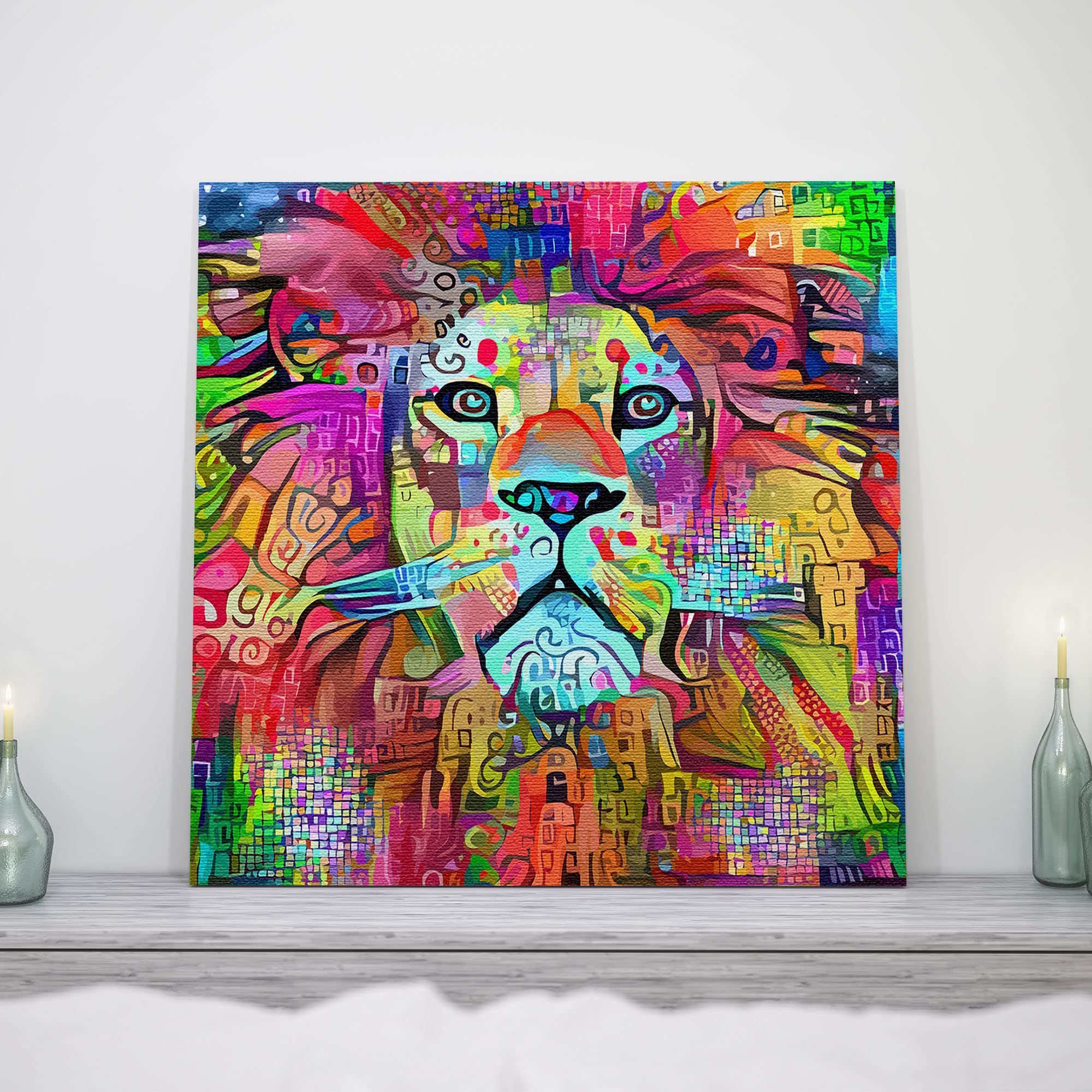 Colorful abstract lion artwork on square canvas displayed on white wall above modern light wooden surface with glass candle holders