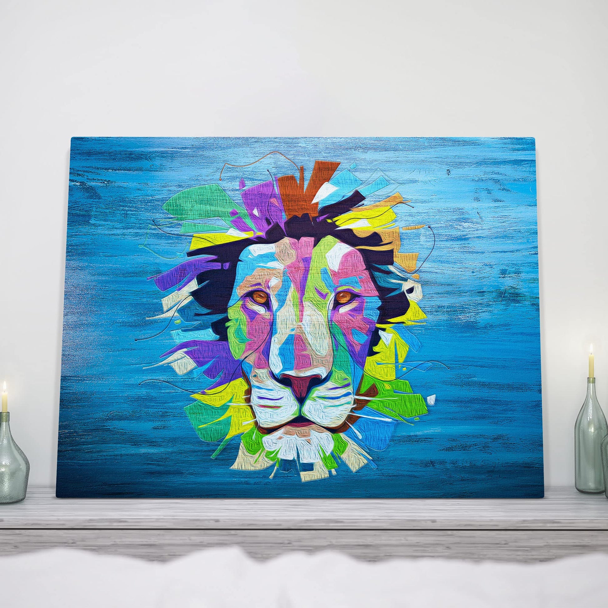 Colorful pop art lion face artwork on vibrant blue textured canvas displayed on white mantel with candles and decor