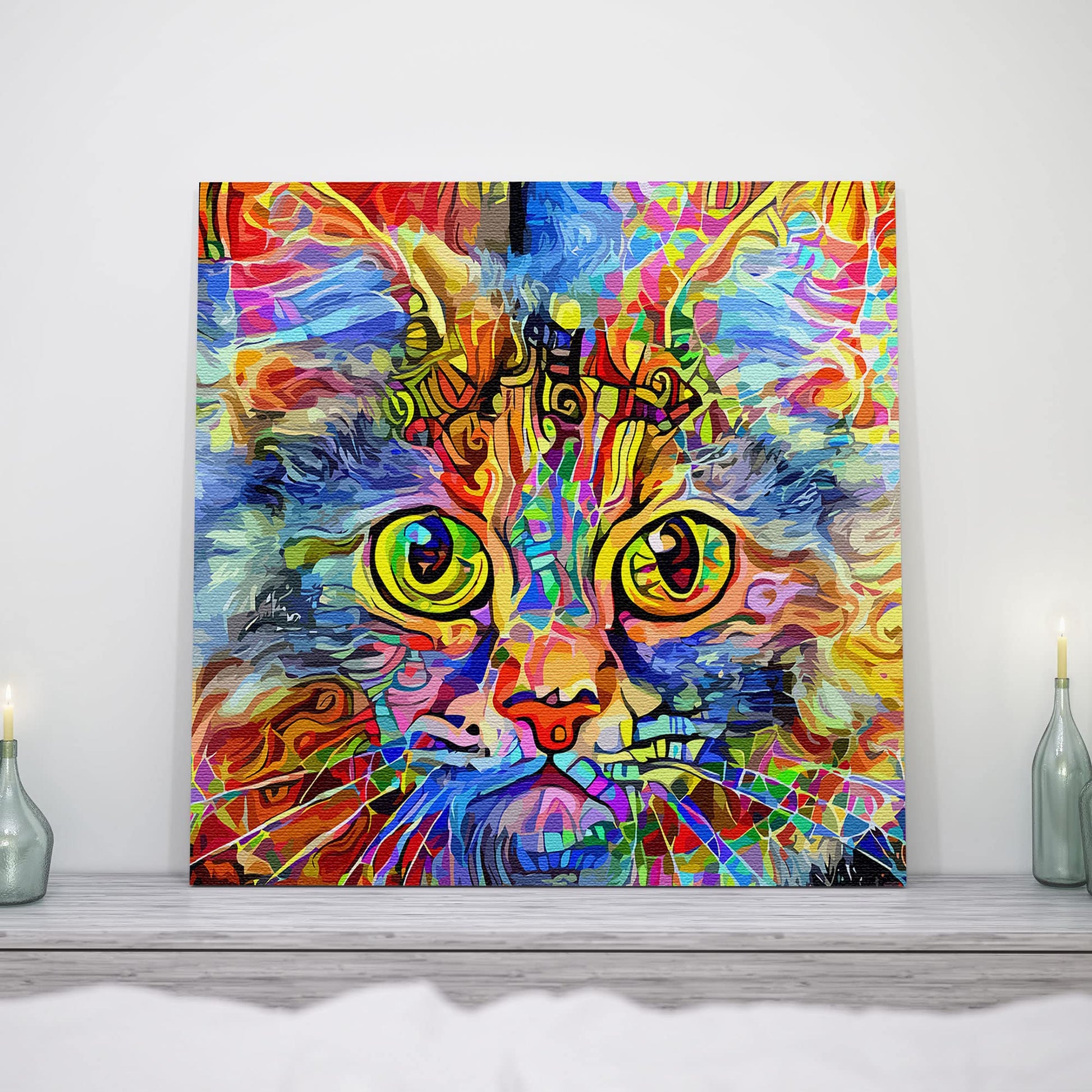 Vibrant cat art canvas with bright multicolor abstract patterns and large expressive yellow-green eyes on square canvas above mantel